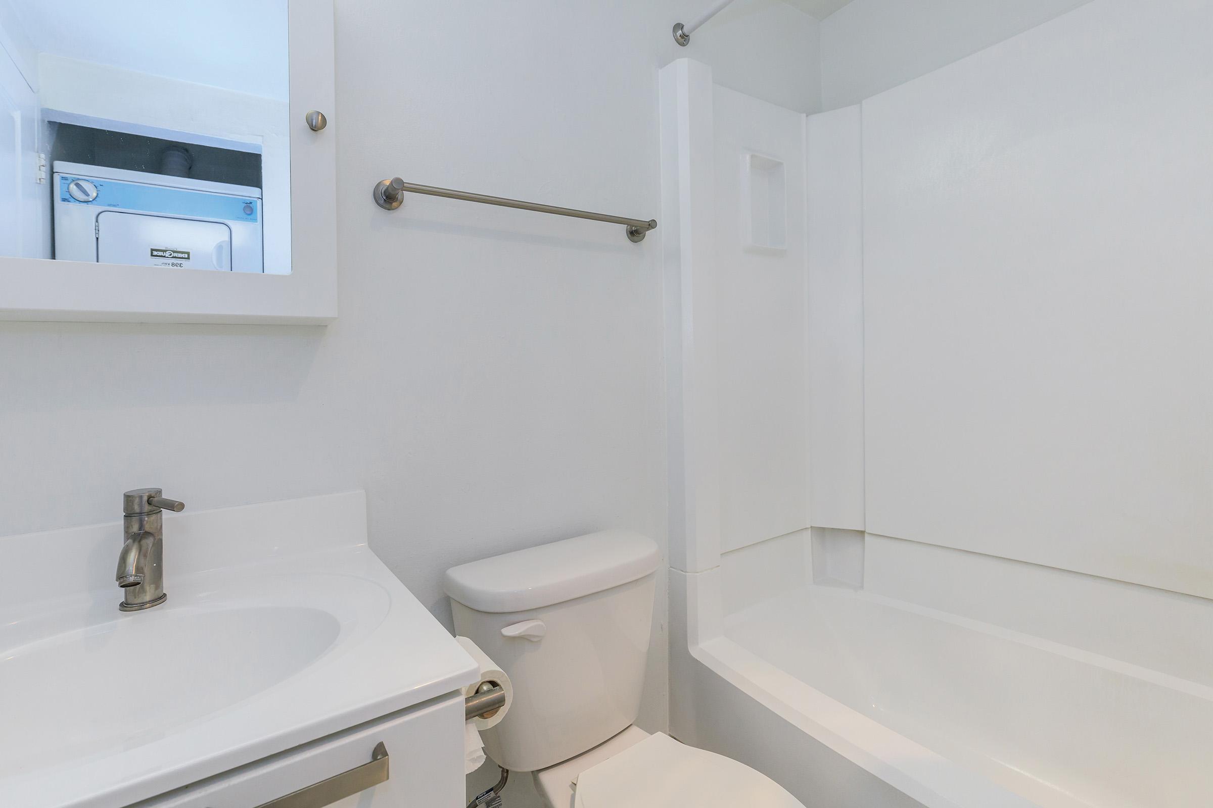 a white tub sitting next to a sink