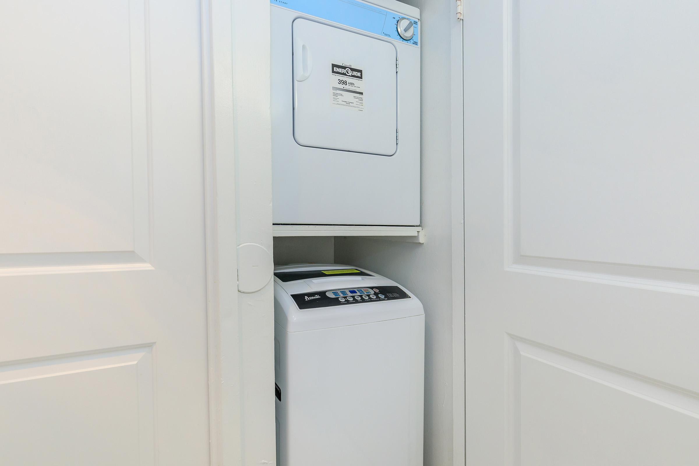 a white microwave oven sitting on top of a refrigerator
