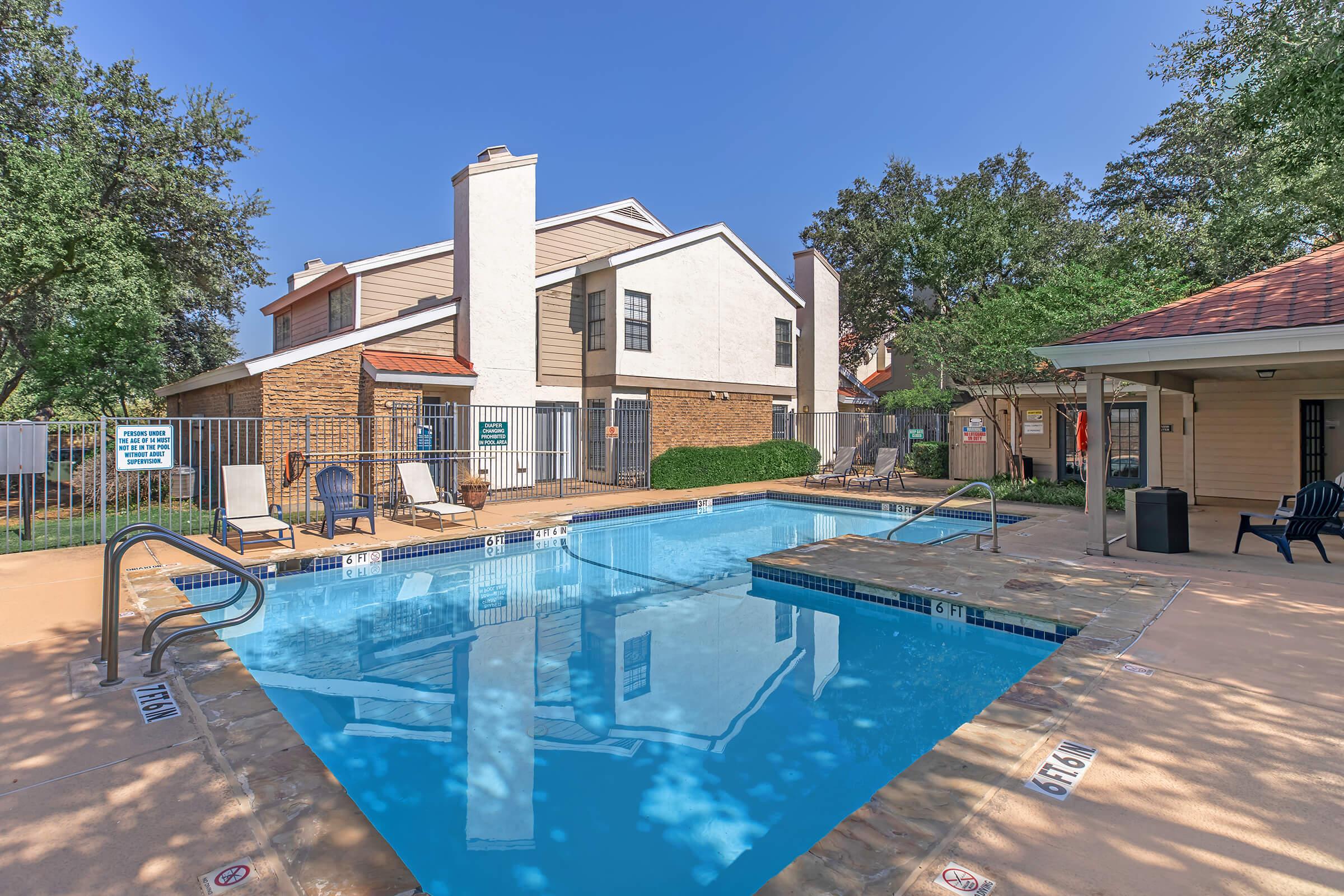 a house with a pool outside of a building