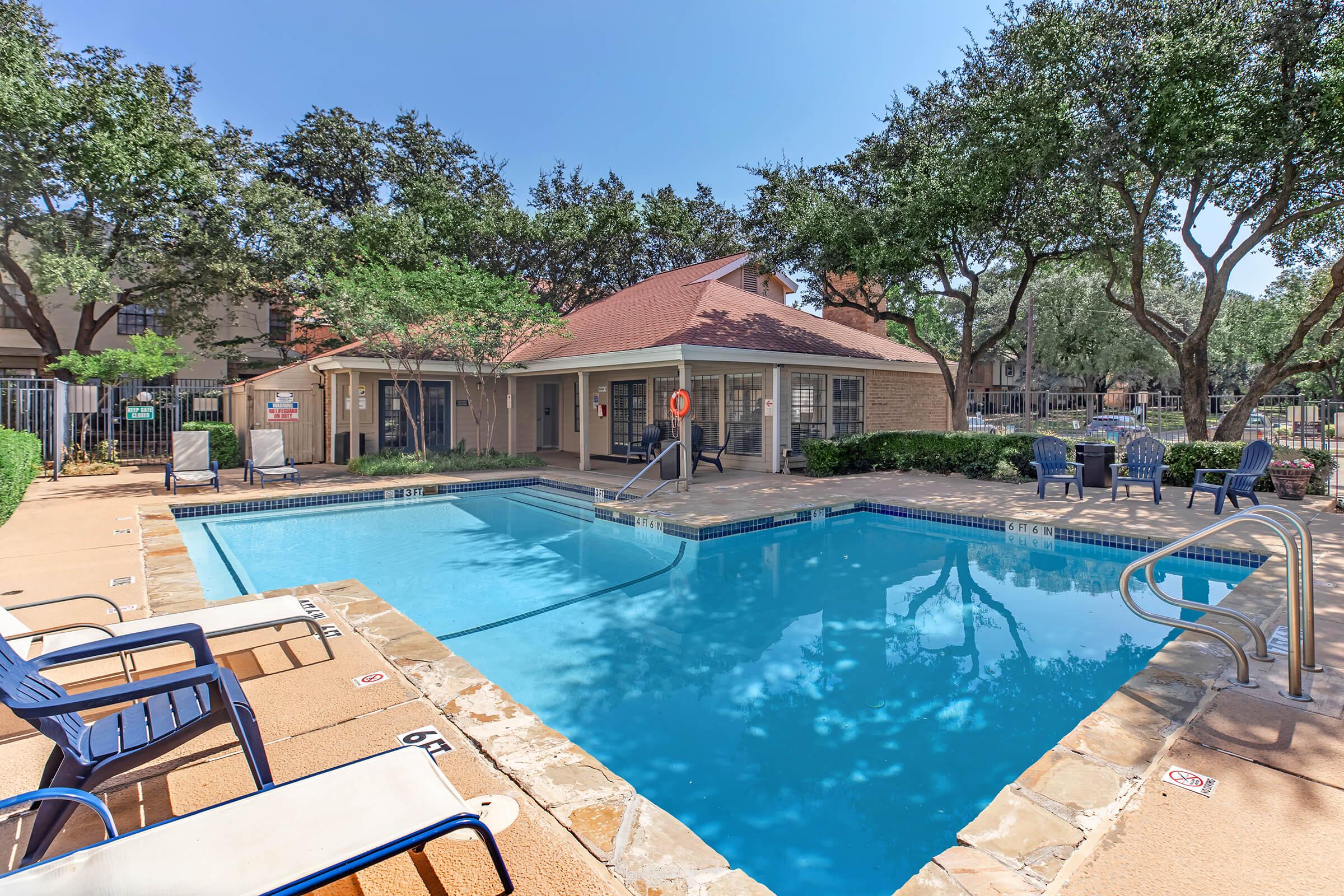 a house with a pool outside of a building