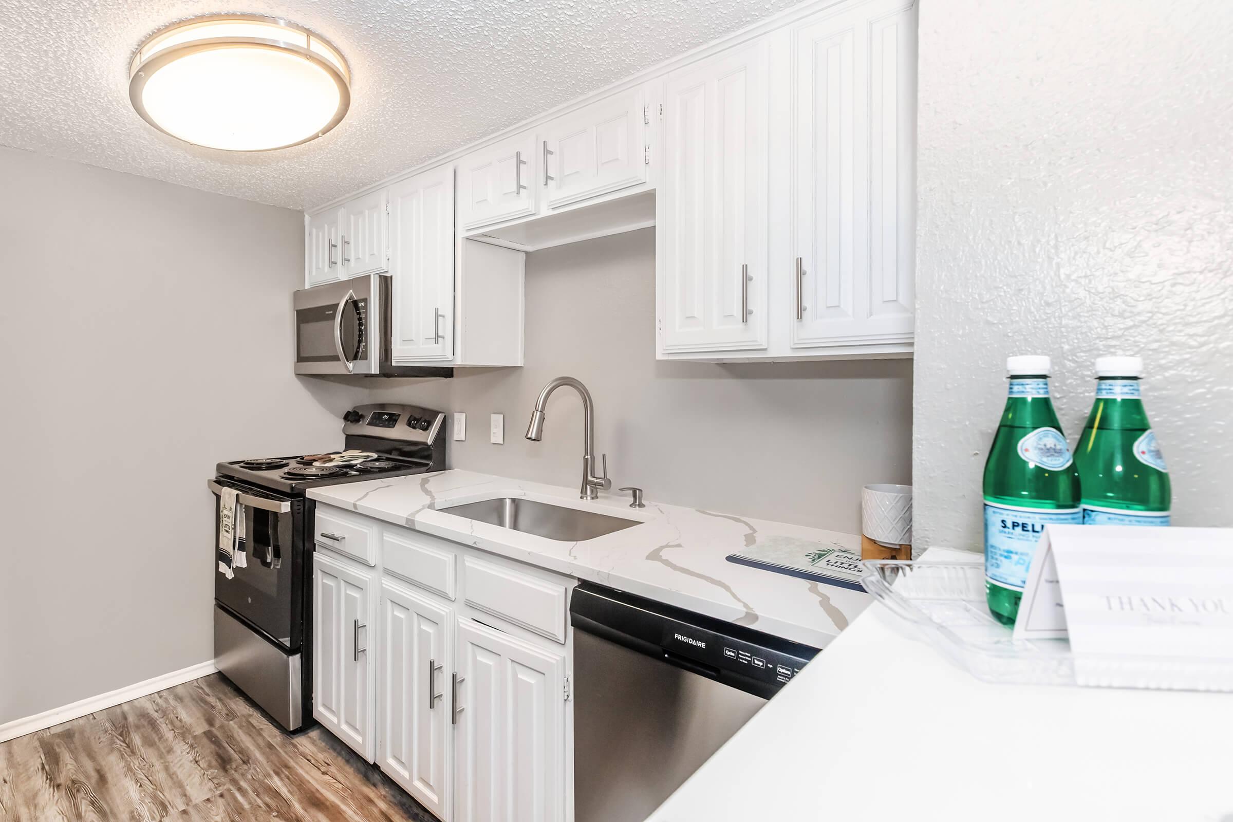 a kitchen with a sink and a refrigerator