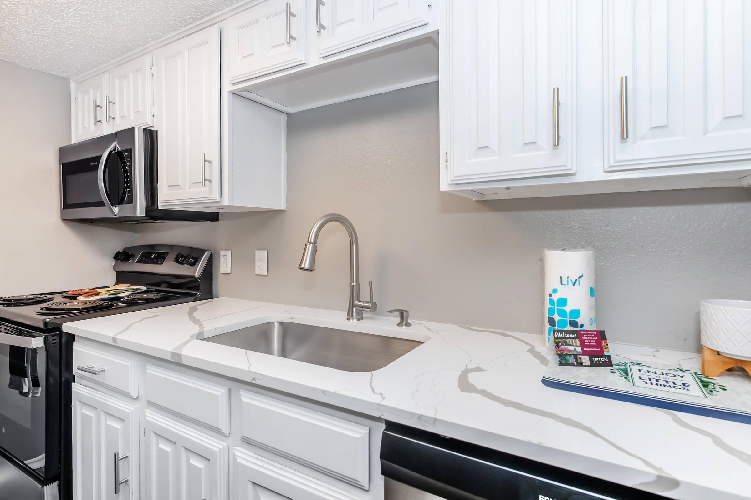 a kitchen with a sink and a microwave