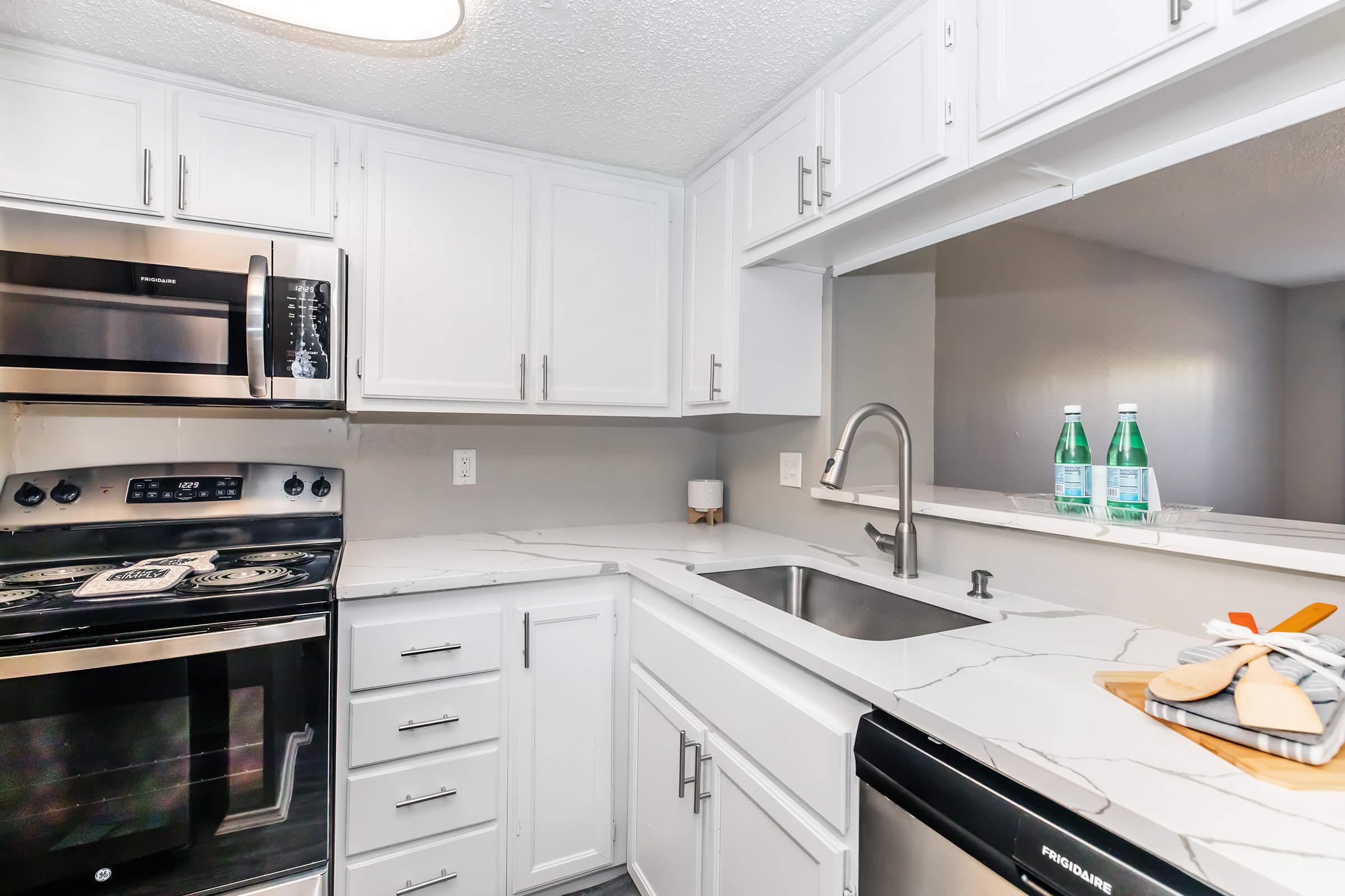 a stove top oven sitting inside of a kitchen