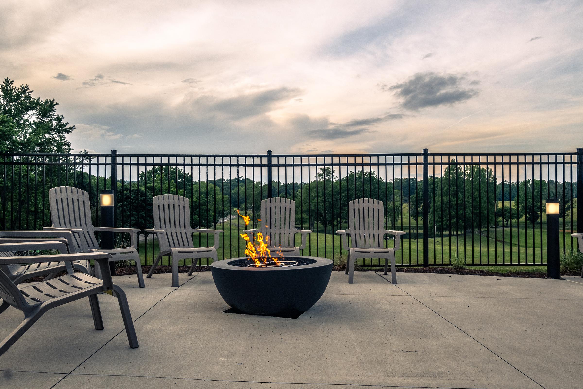 a bench is sitting in front of a fence