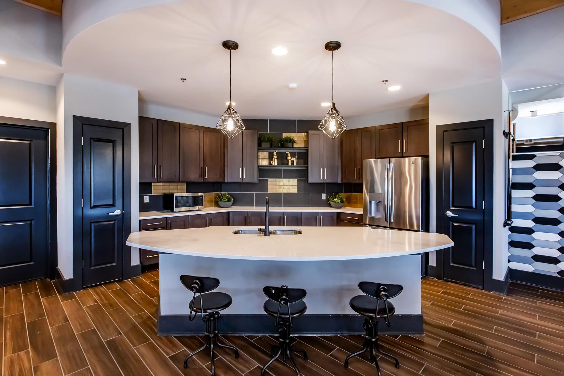 a modern kitchen with stainless steel appliances and wooden cabinets