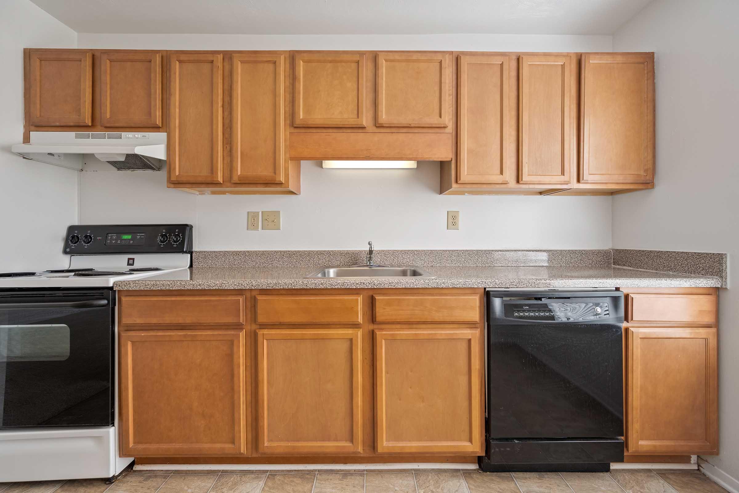 a kitchen with wooden cabinets and a microwave