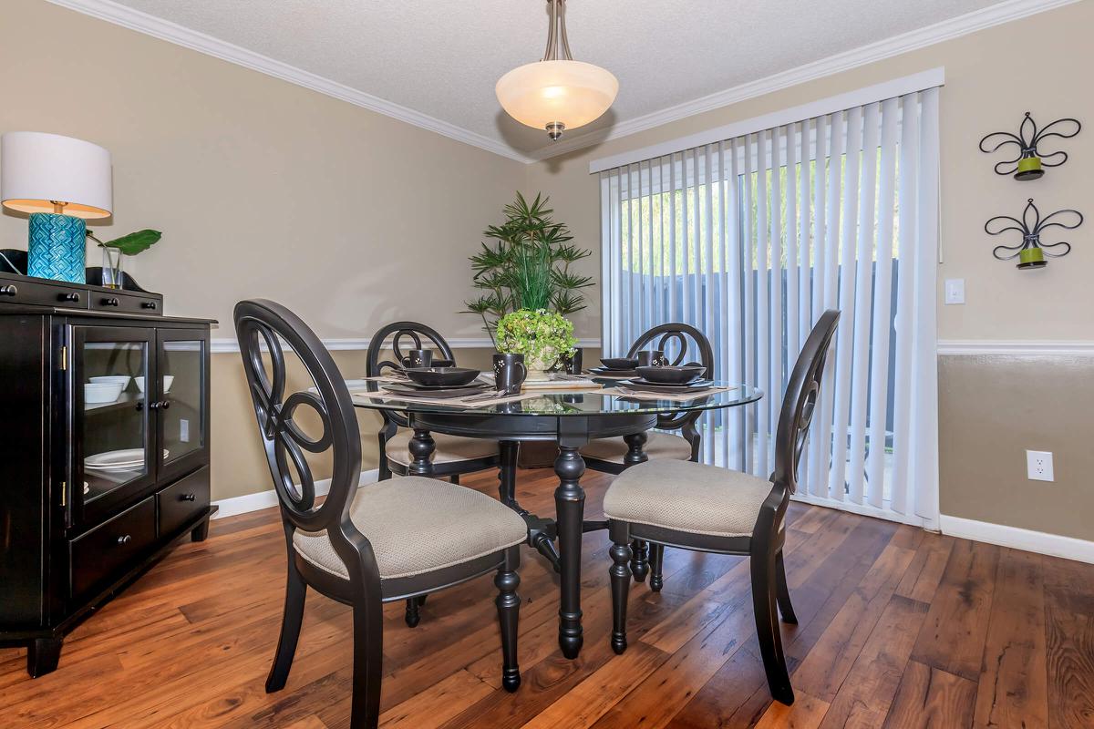 a living room filled with furniture on top of a hard wood floor