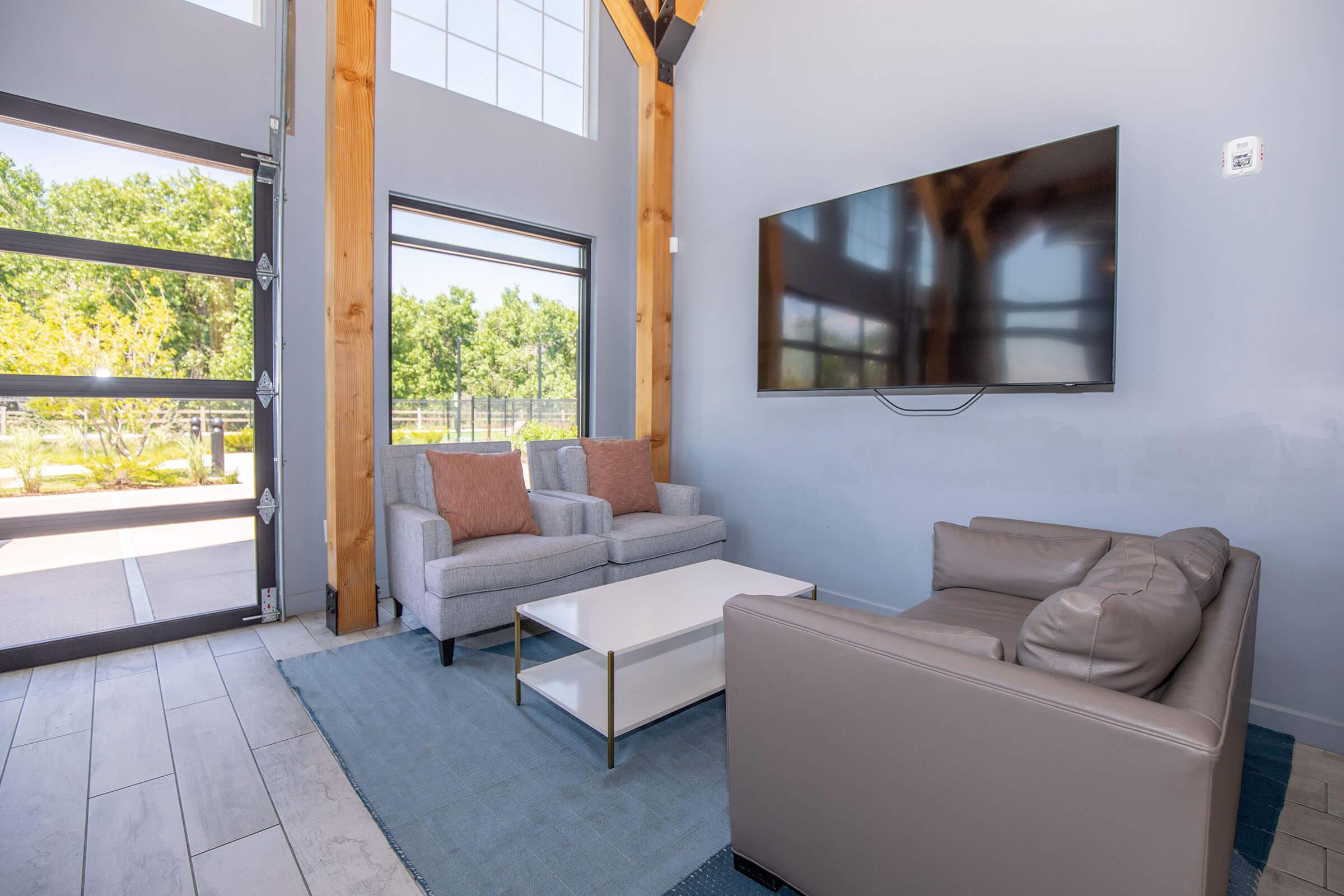 a living room filled with furniture and a large window