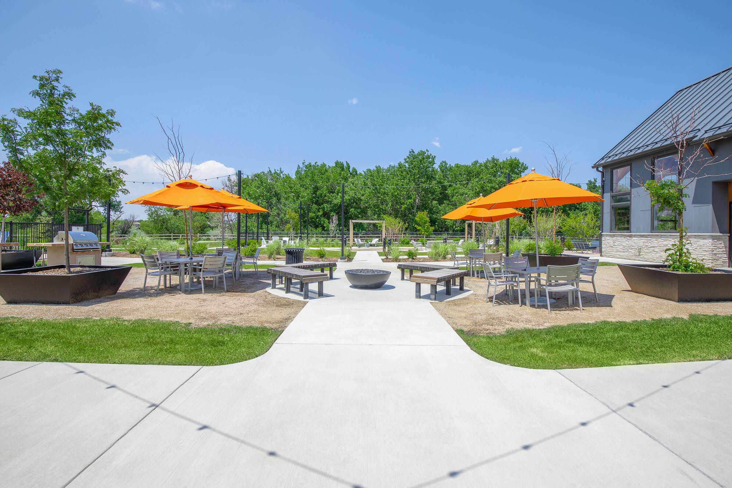 a group of lawn chairs sitting under an umbrella