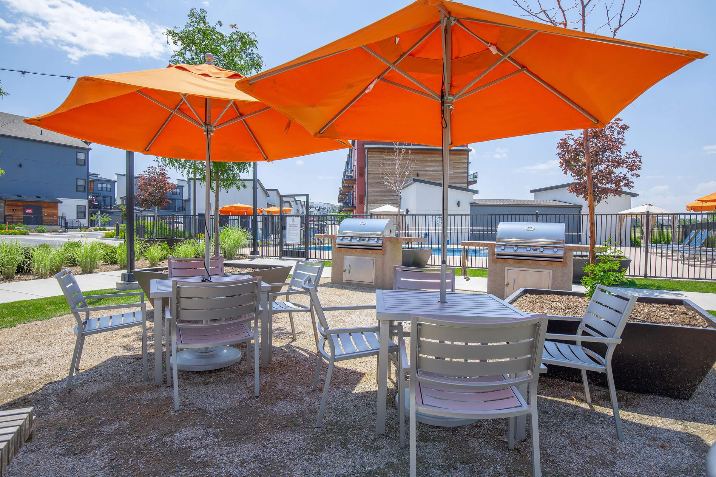 a group of lawn chairs under an umbrella