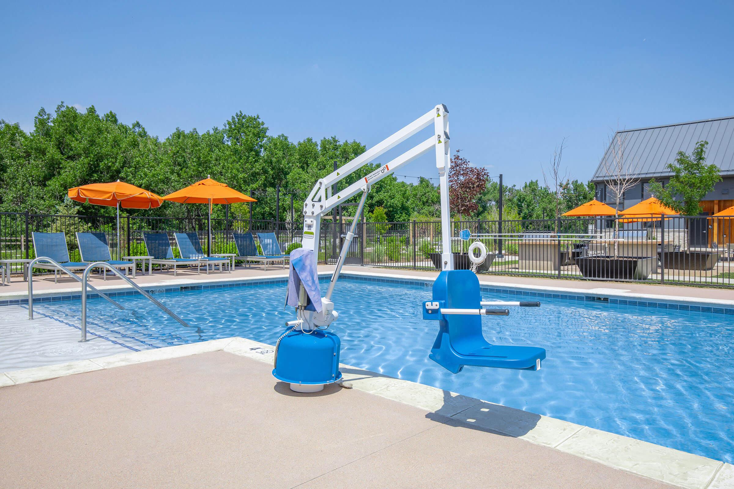 a blue umbrella sitting next to a pool of water