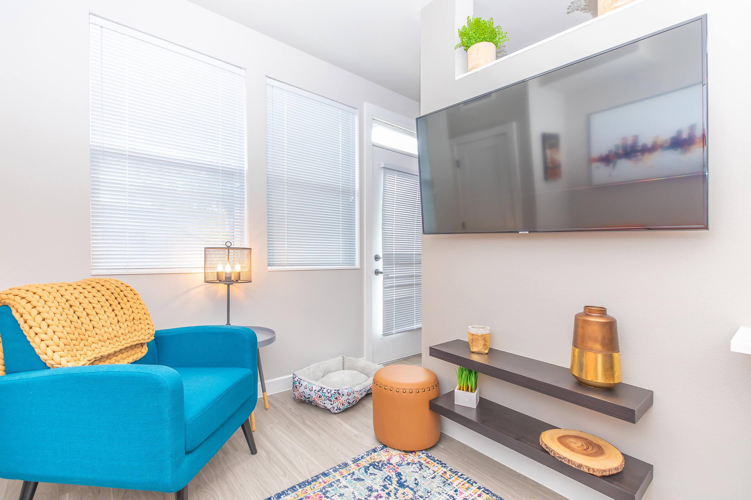 a living room filled with furniture and a large window