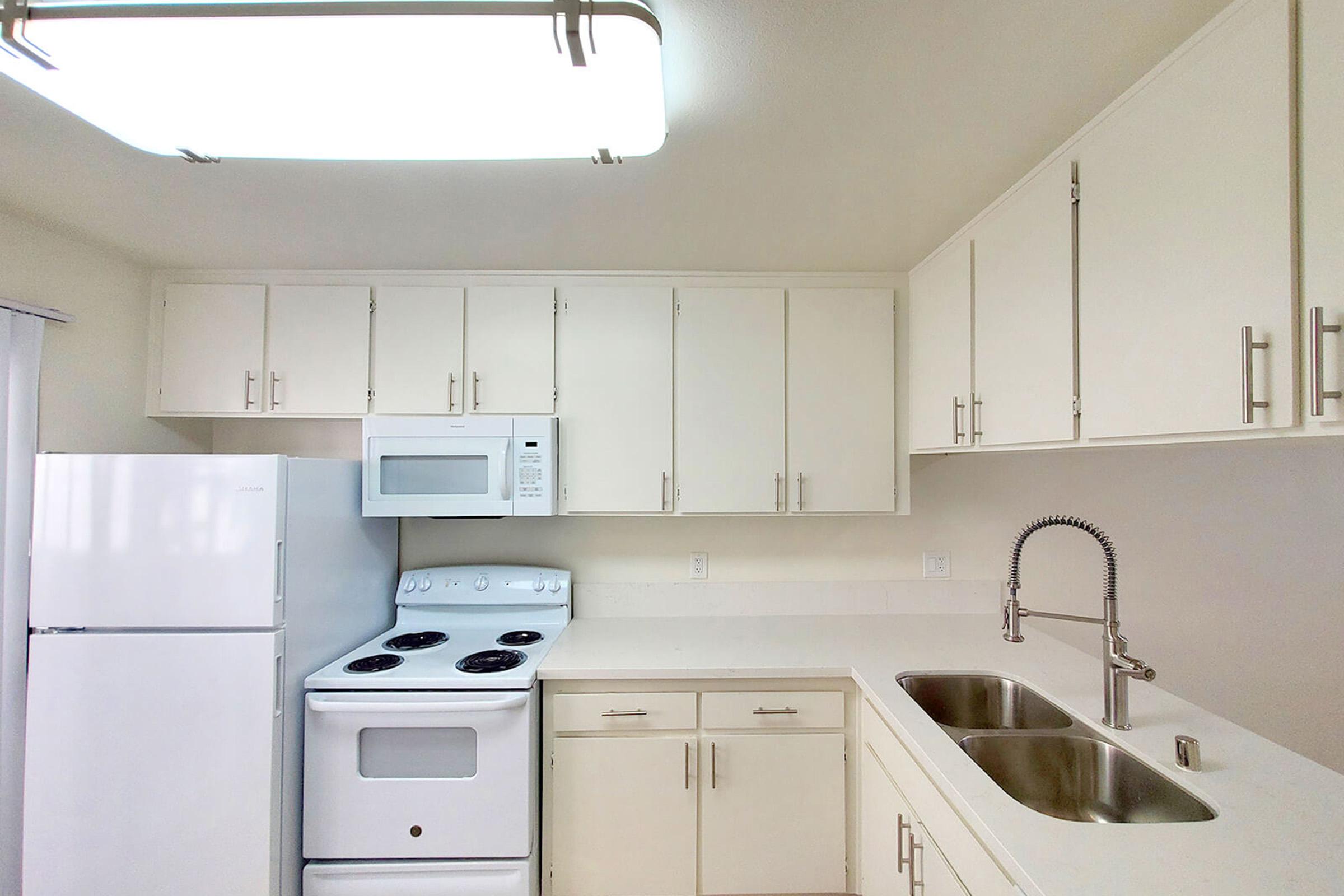 a kitchen with a stove top oven sitting inside of a refrigerator