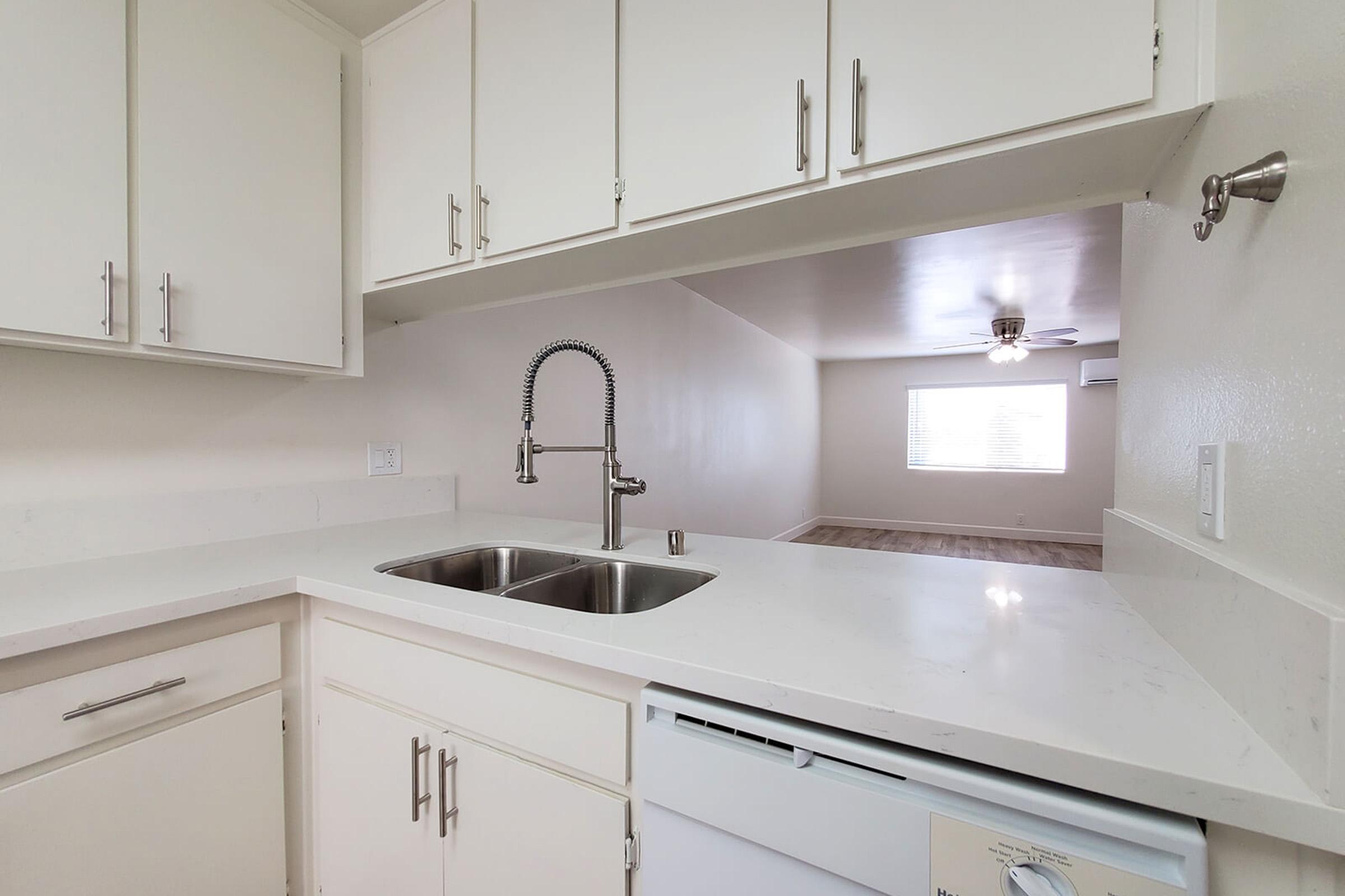 a kitchen with a sink and a mirror