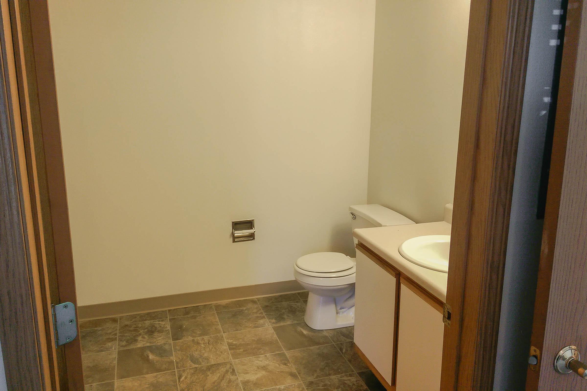 a white sink sitting under a mirror