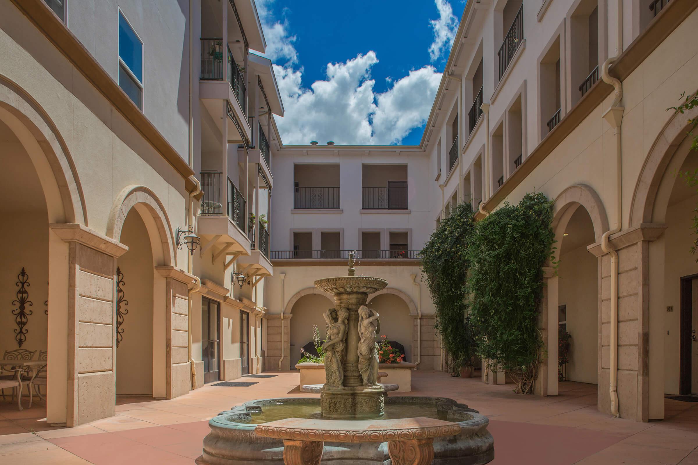 a large stone statue in front of a building