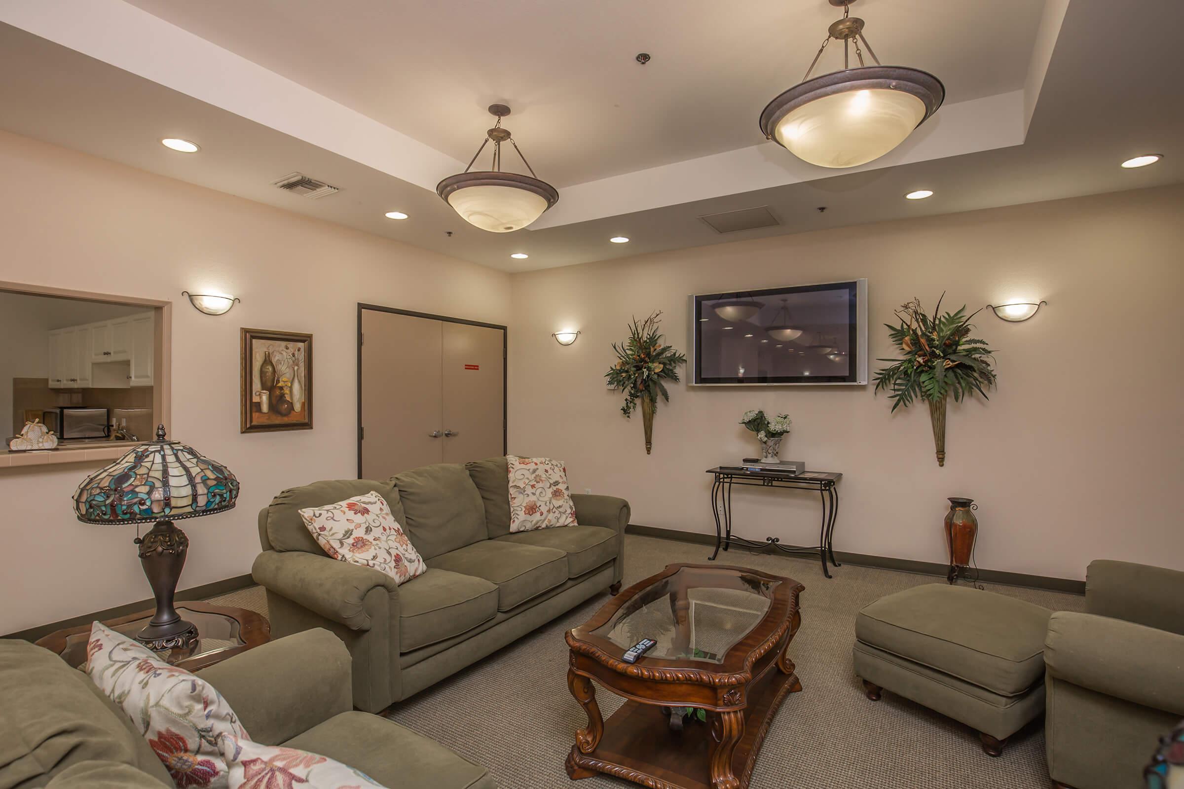 a living room filled with furniture and a flat screen tv