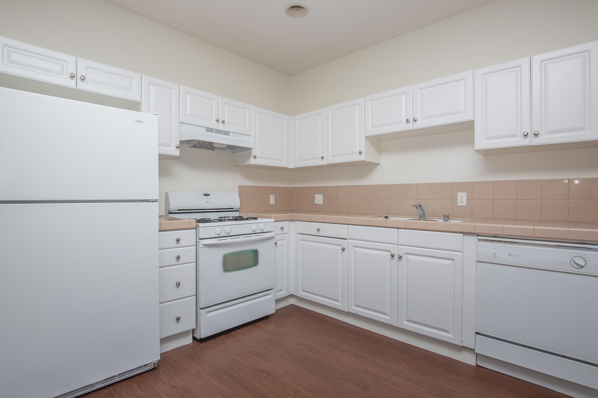 a white refrigerator freezer sitting inside of a kitchen