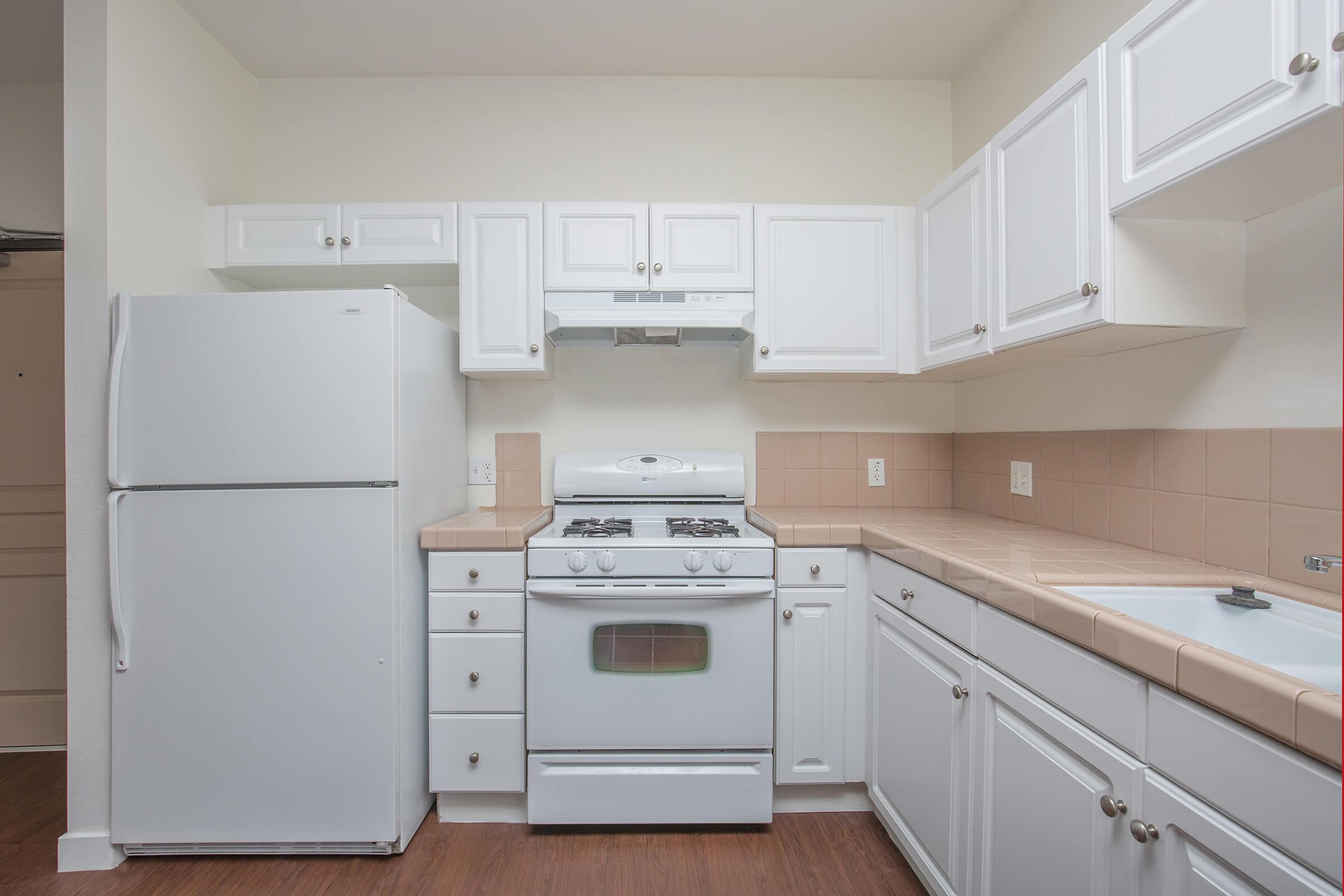 a white stove top oven sitting inside of a kitchen