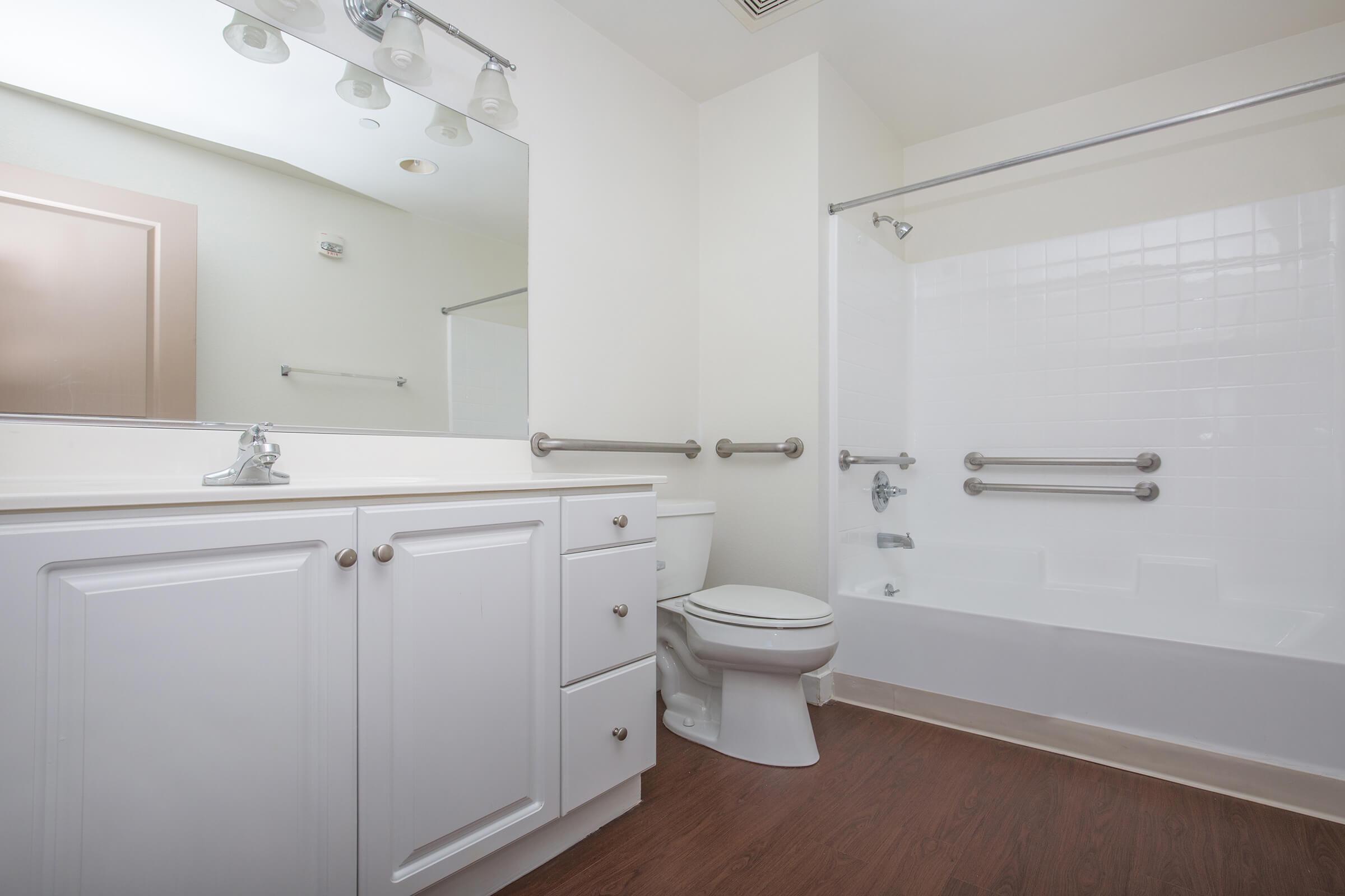 a white tub sitting next to a shower