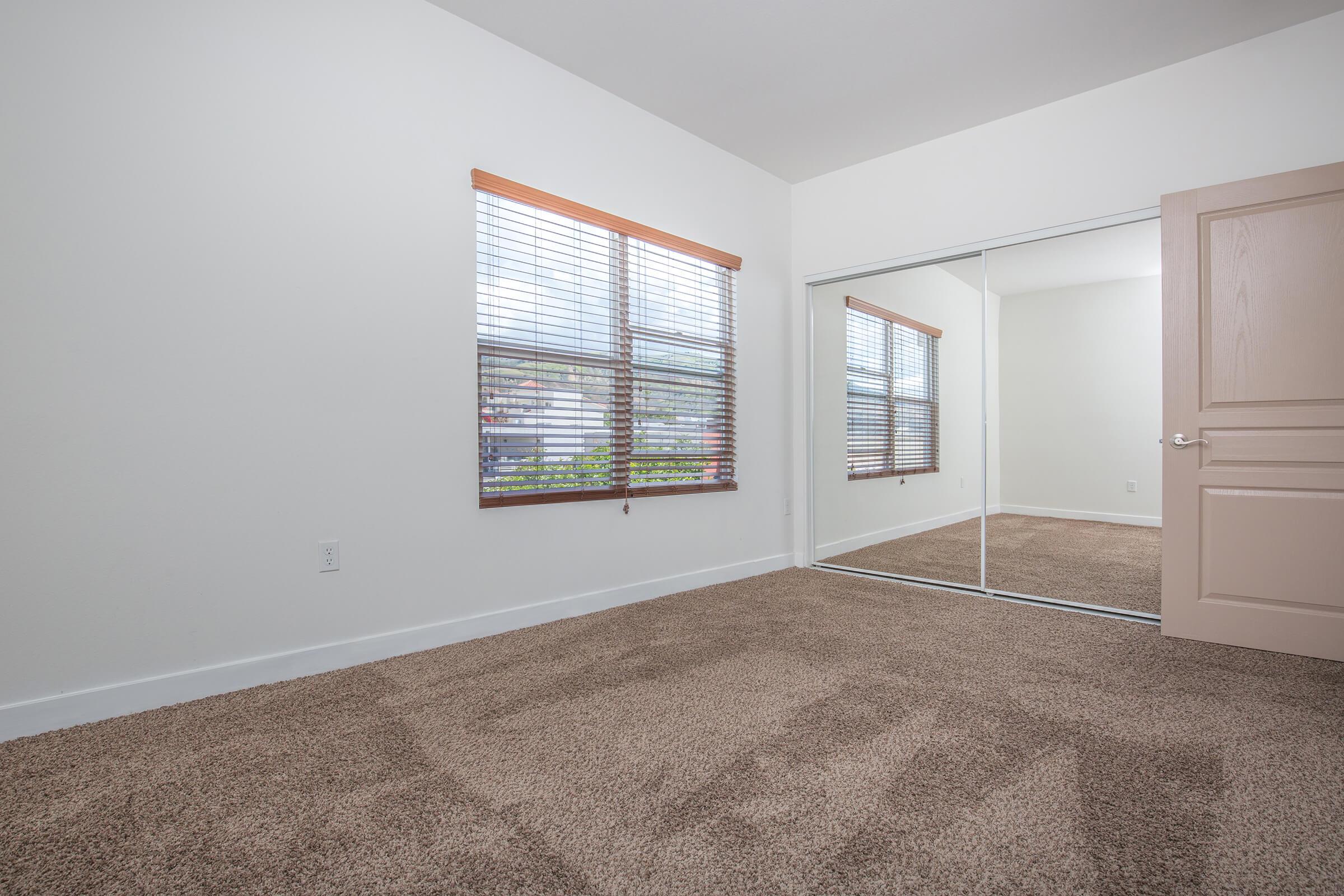 a bedroom with a large window