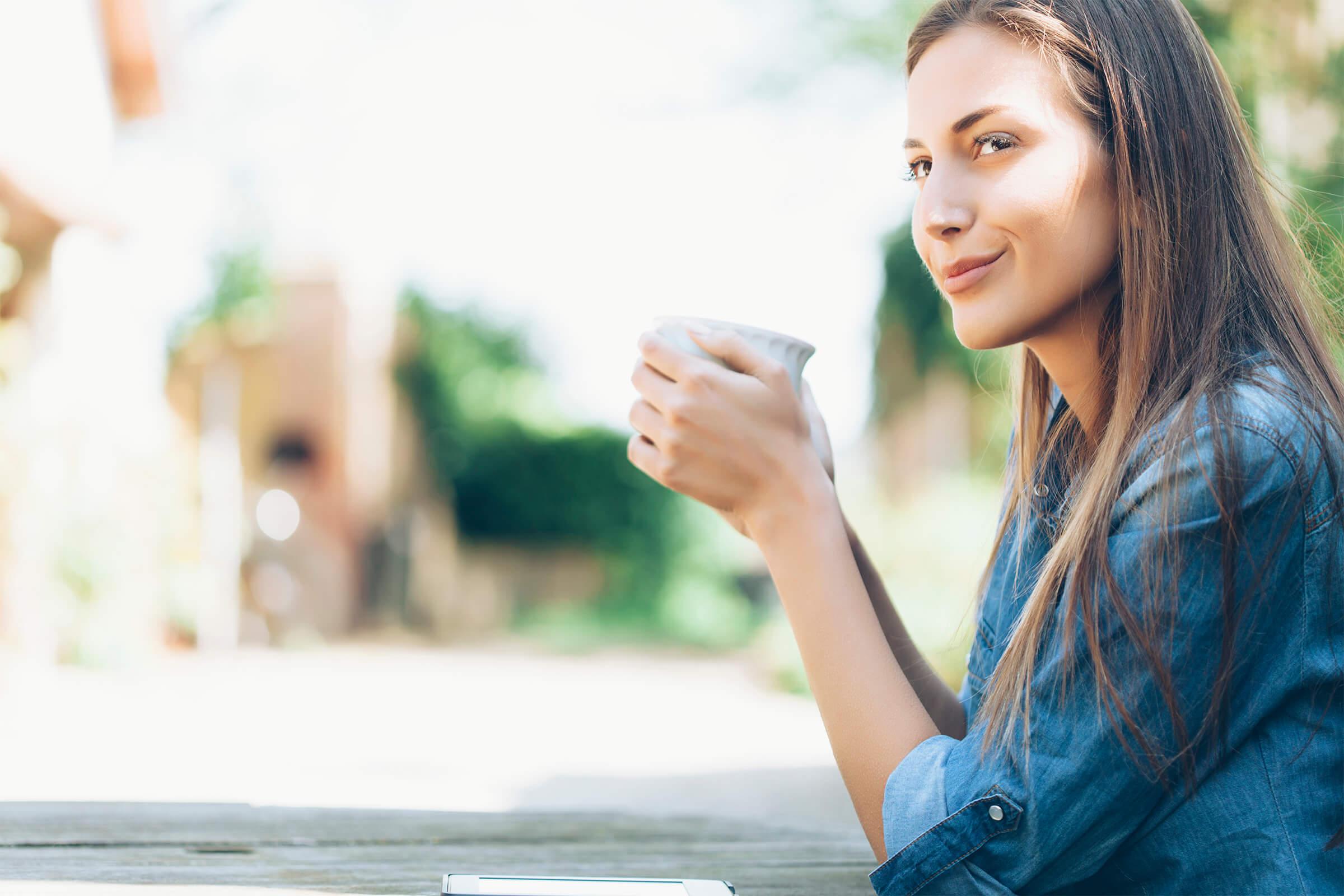 amenities-outdoor-laying on grass-Young woman sitting outdoors .jpg