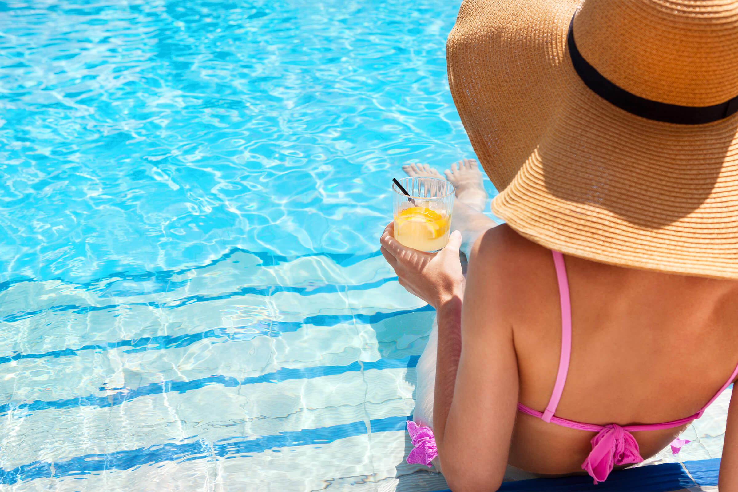woman in hat pool side - iStock-639233998.jpg