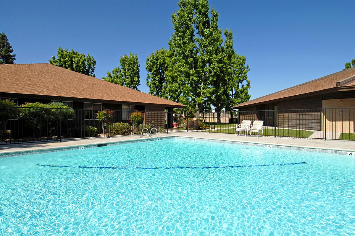 Redwood Glen Apartments community pool with green trees