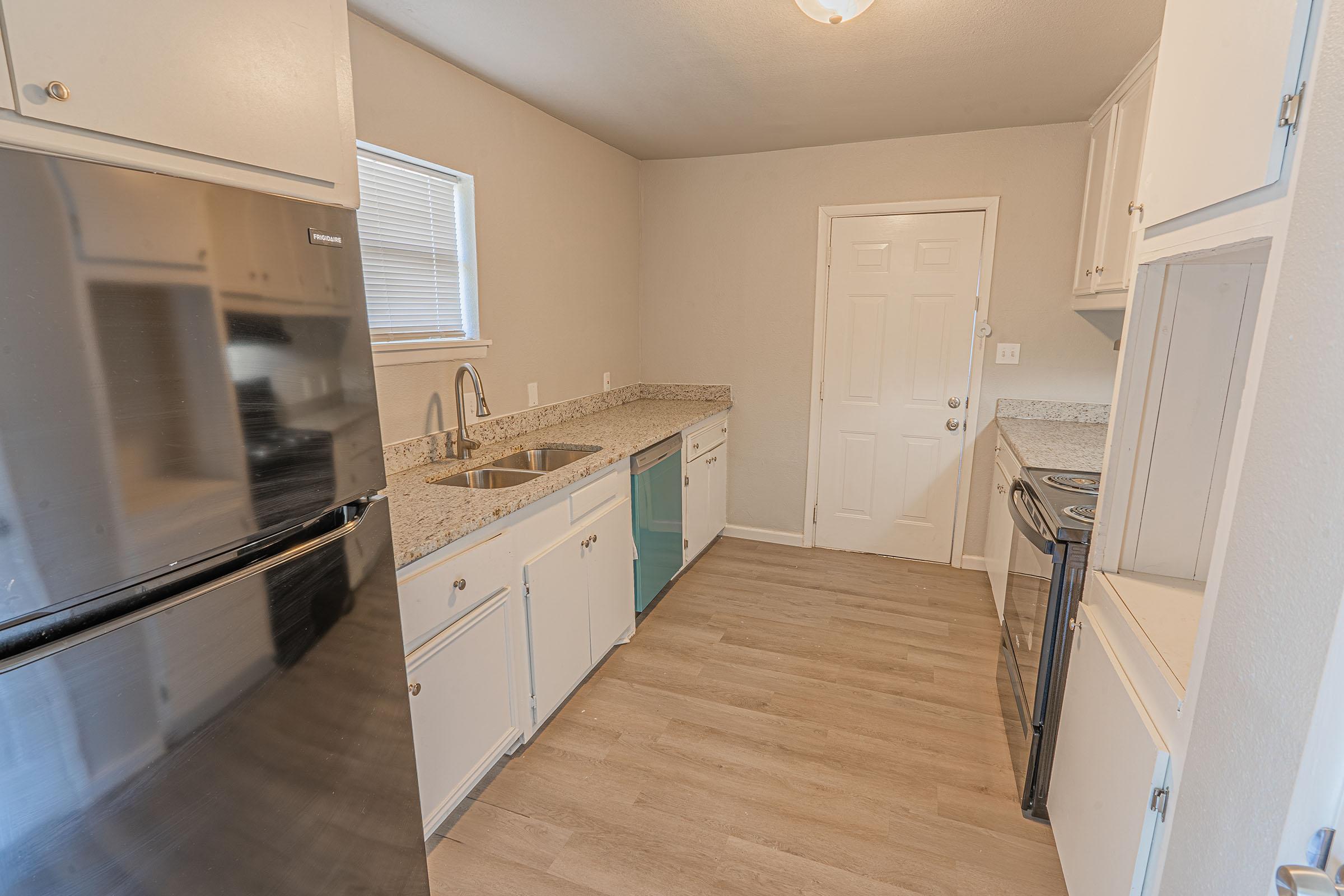 a kitchen with a stove top oven sitting inside of a room