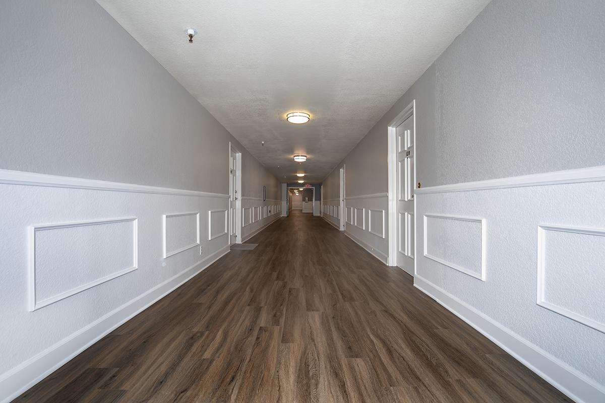 Vacant hallway with wooden floors