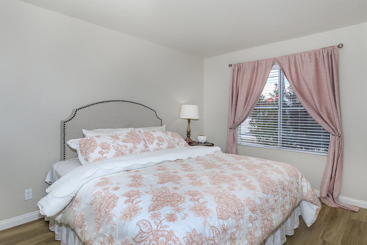 Bedroom with white and pink bedding