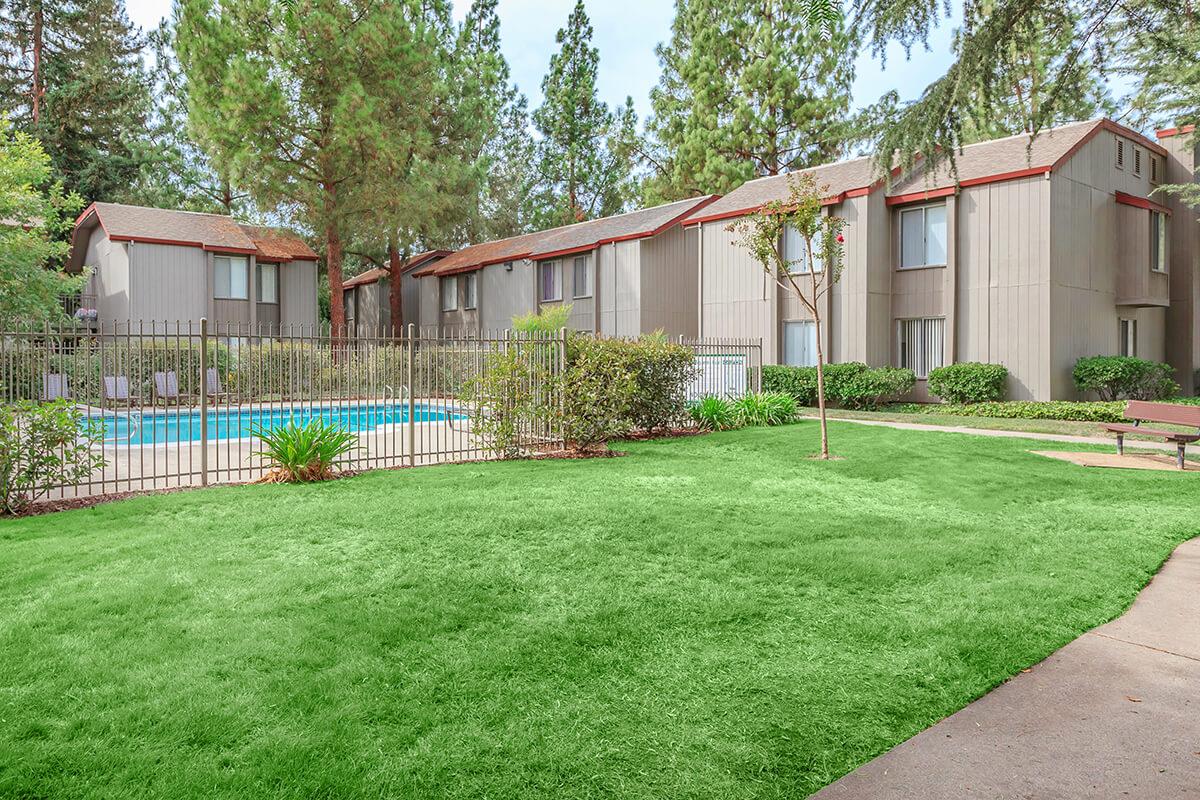 a house with a lawn in front of a building