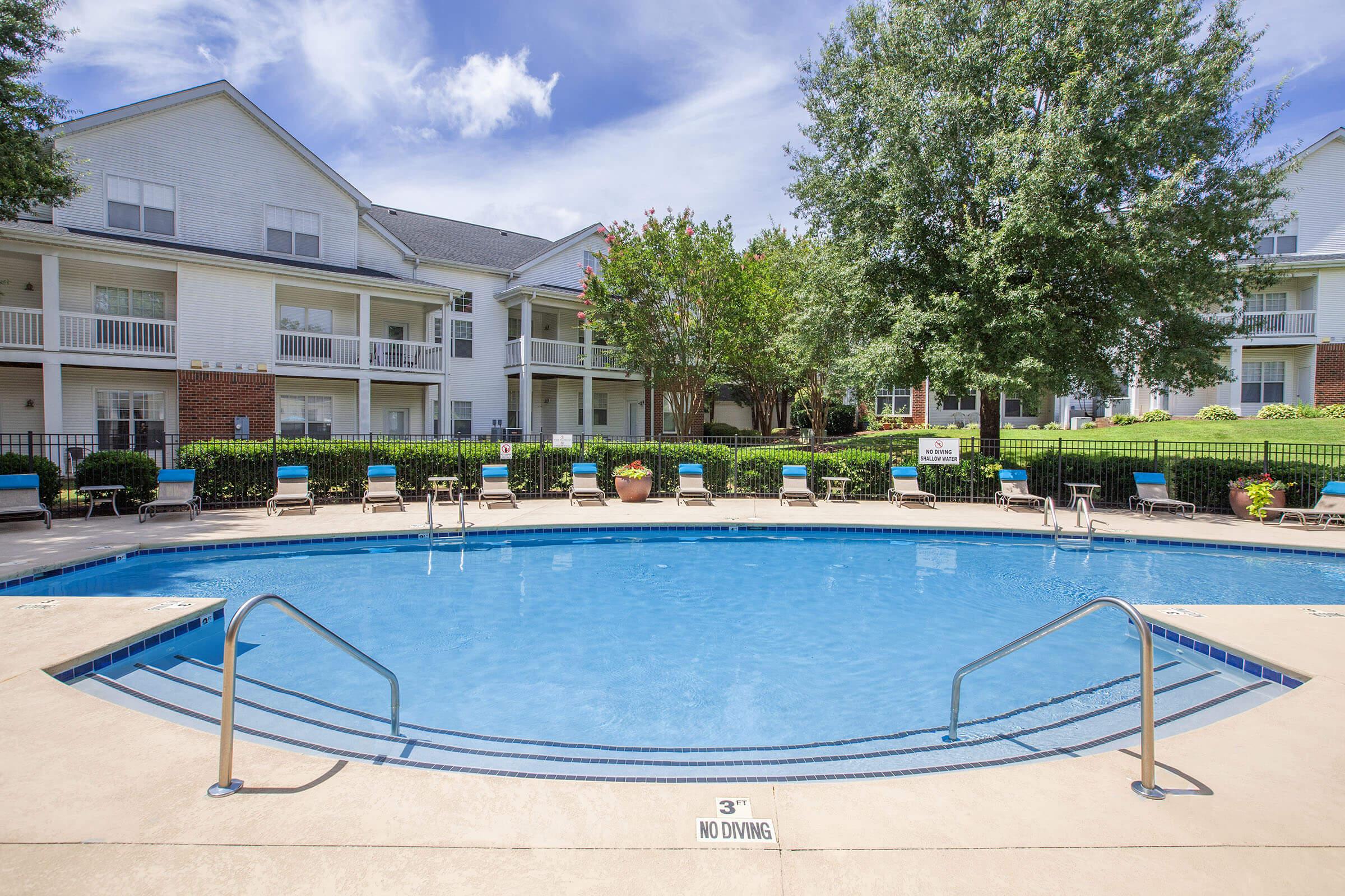 a house with a pool in front of a building