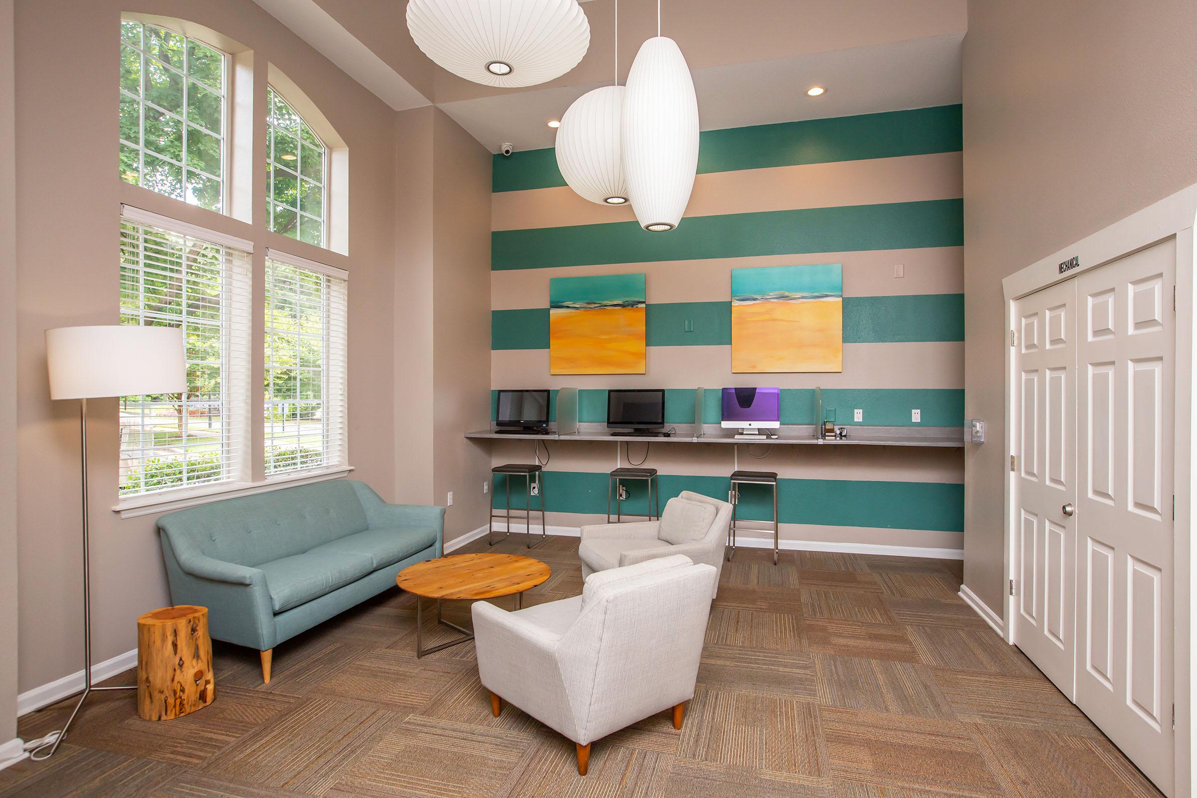 a living room filled with furniture and a large window