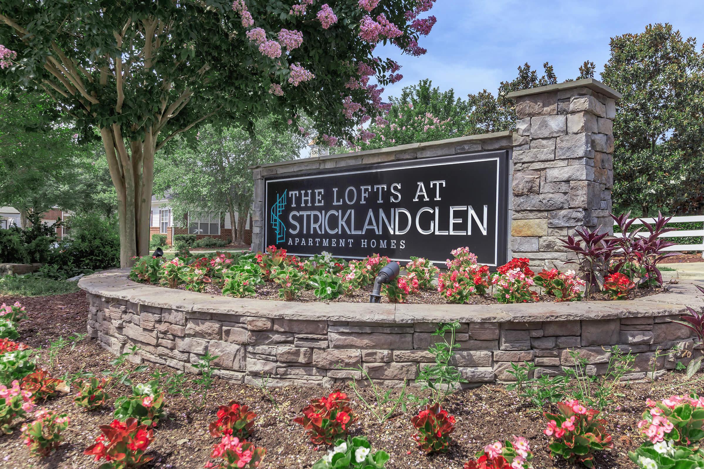 a close up of a flower garden in front of a building