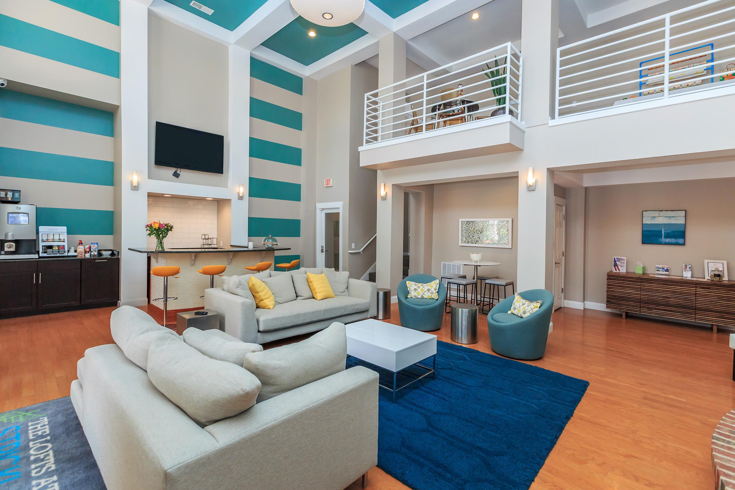 a living room filled with furniture and a large window