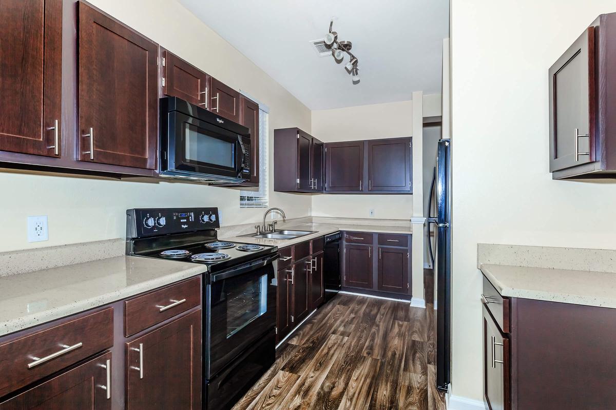 a modern kitchen with stainless steel appliances and wooden cabinets