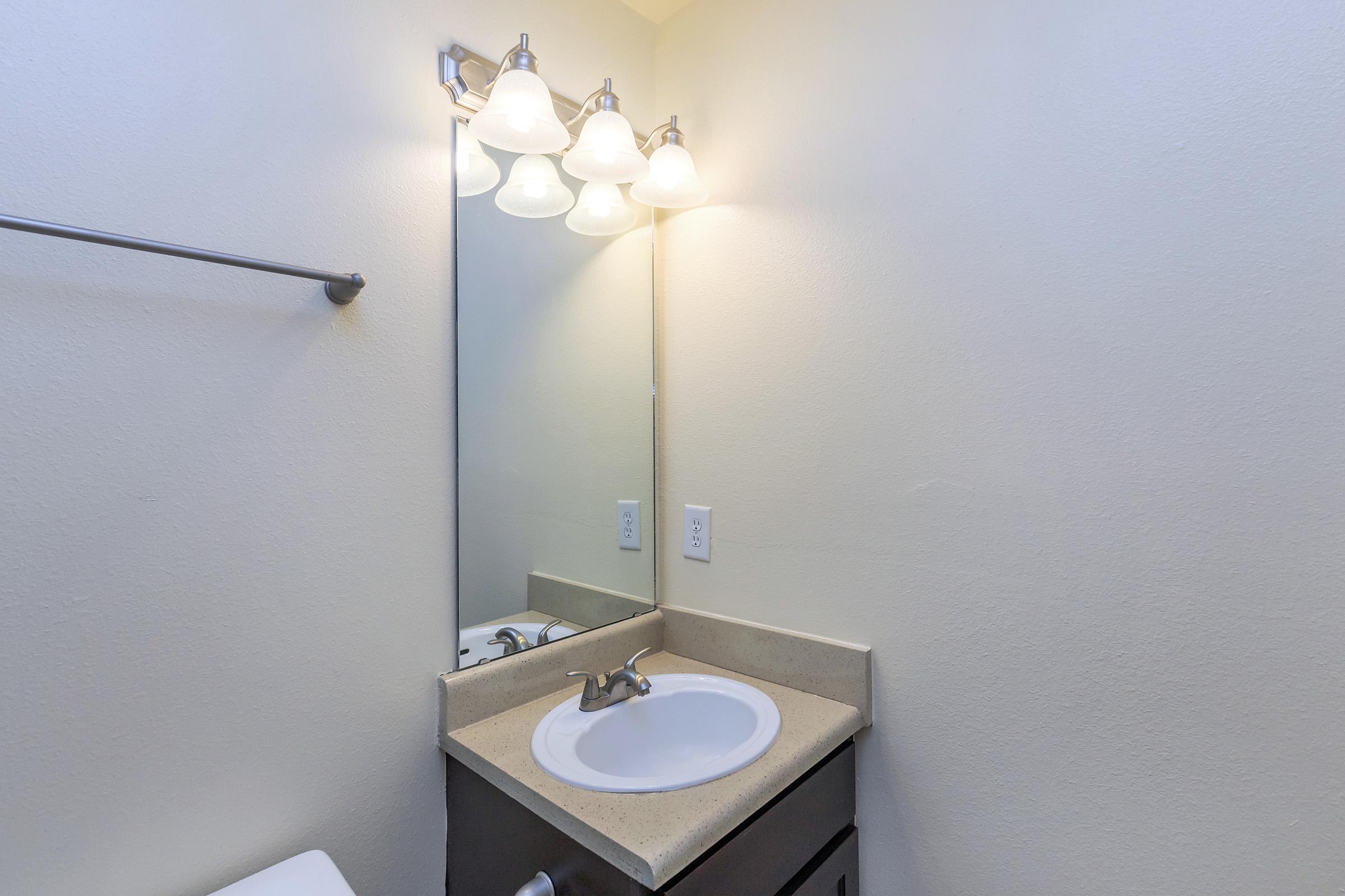 a close up of a sink and a mirror