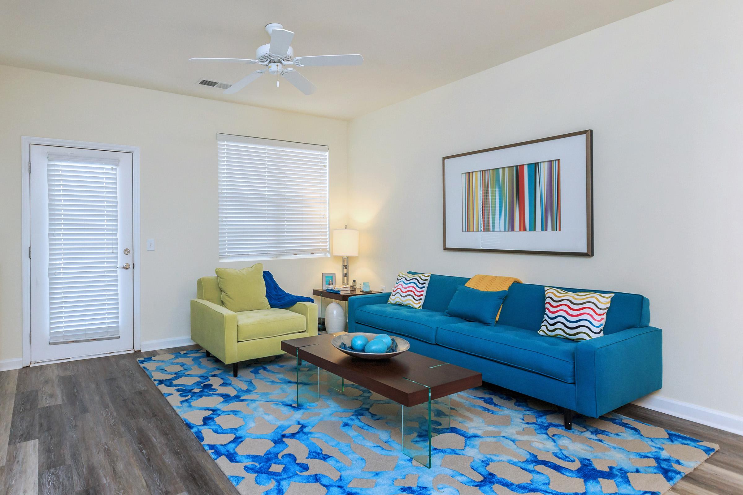 a living room with blue furniture