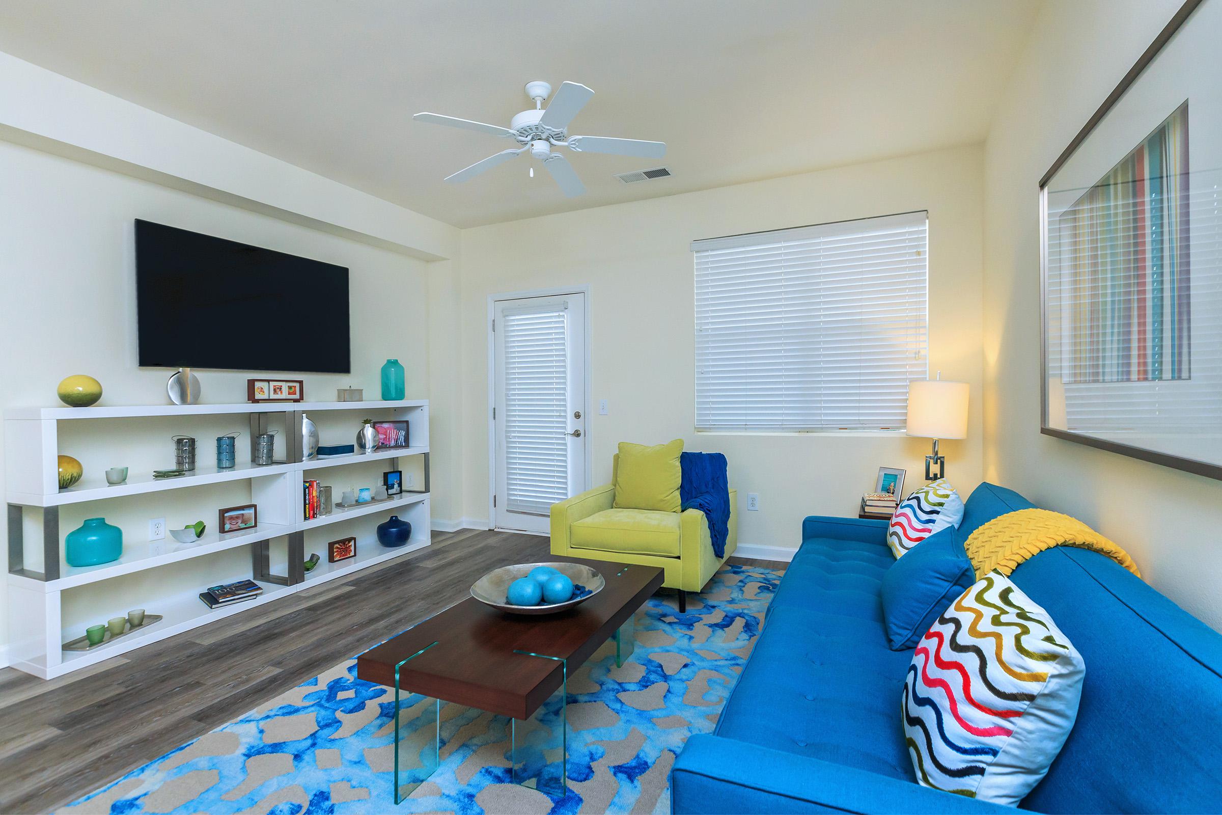 a living room filled with furniture and a window