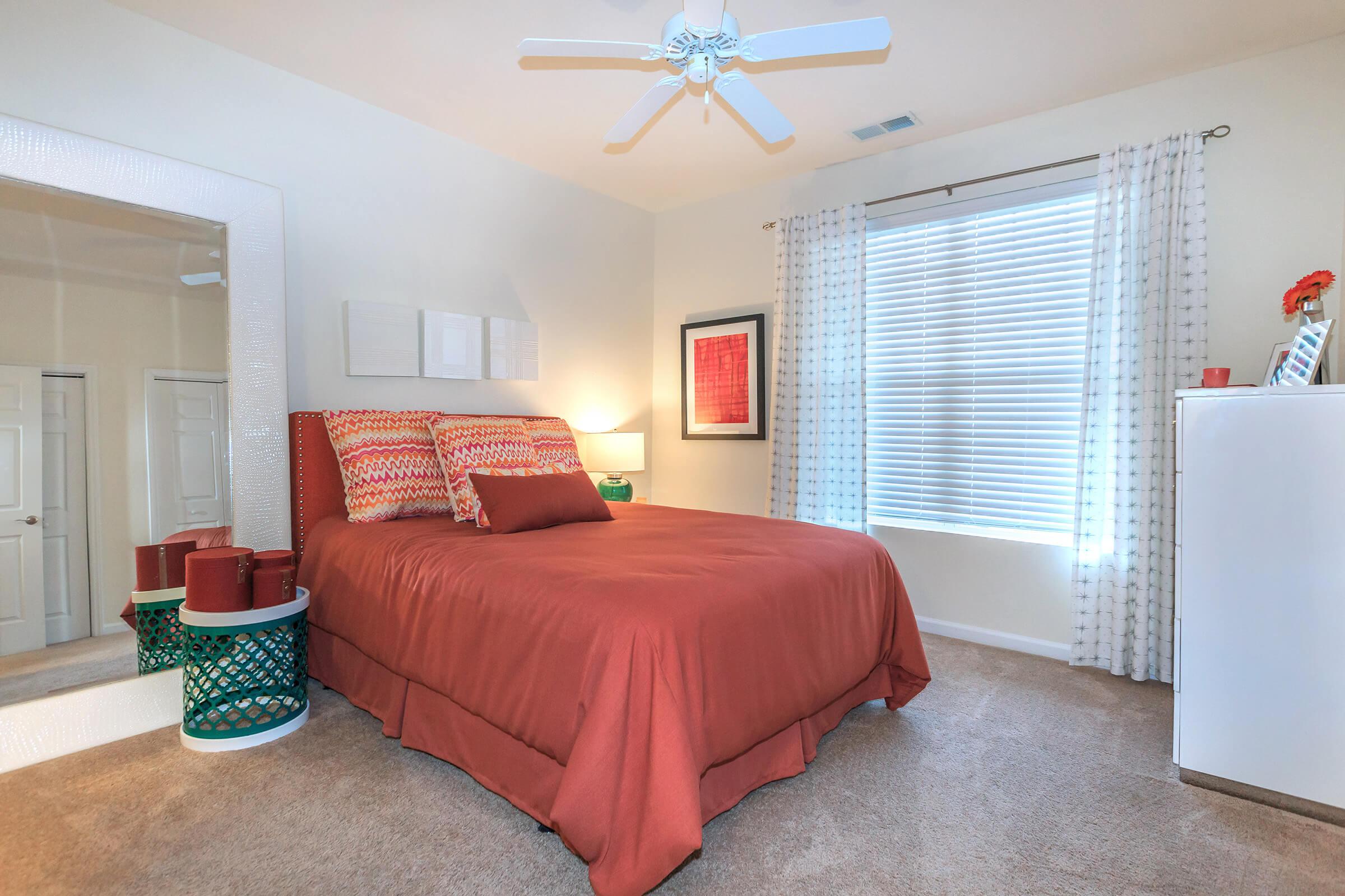 a bedroom with a bed and desk in a room