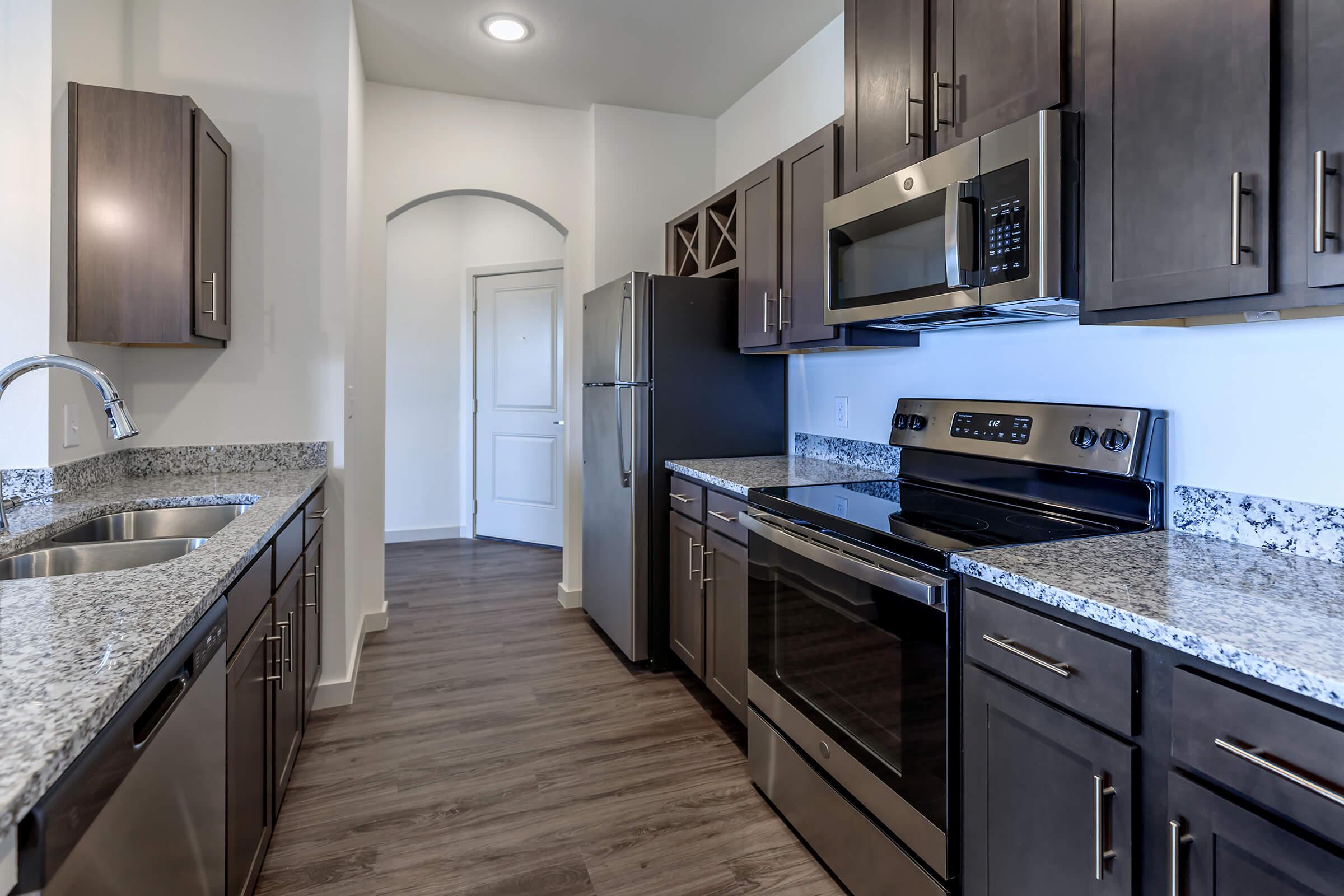 a large kitchen with stainless steel appliances