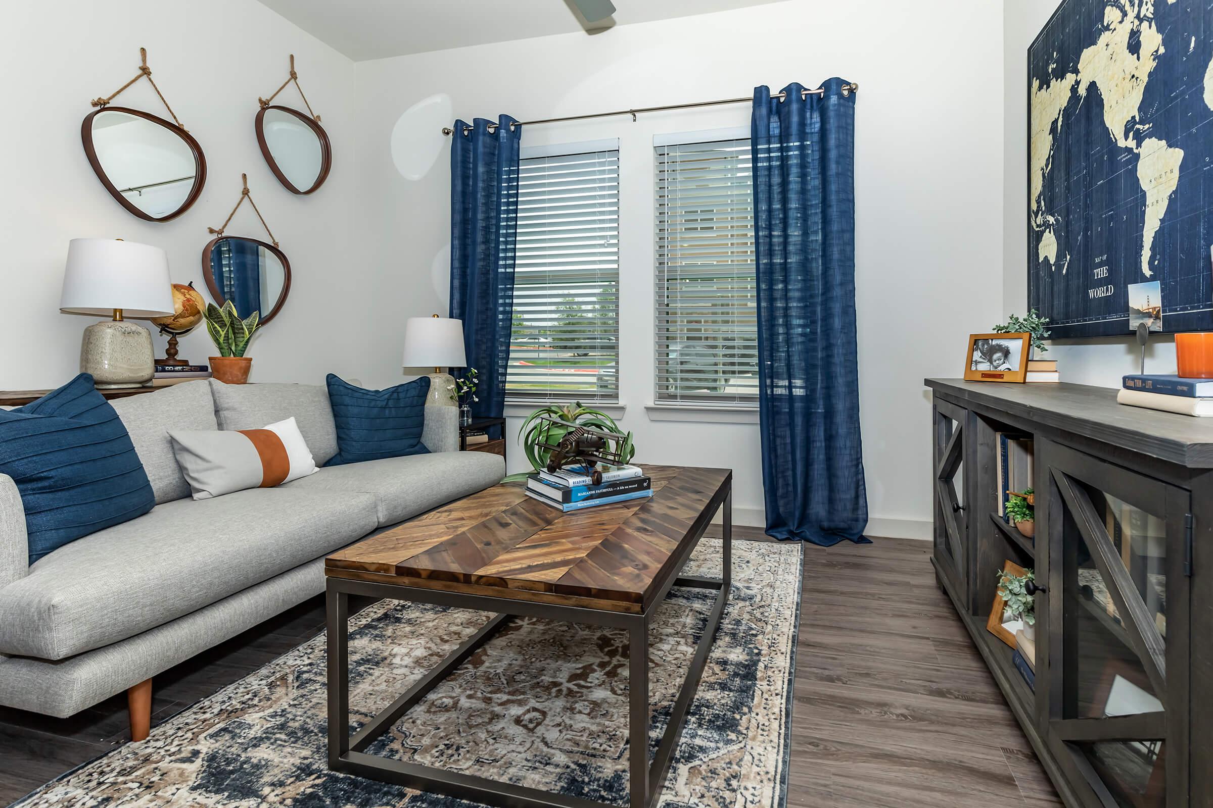 a living room filled with furniture and a table