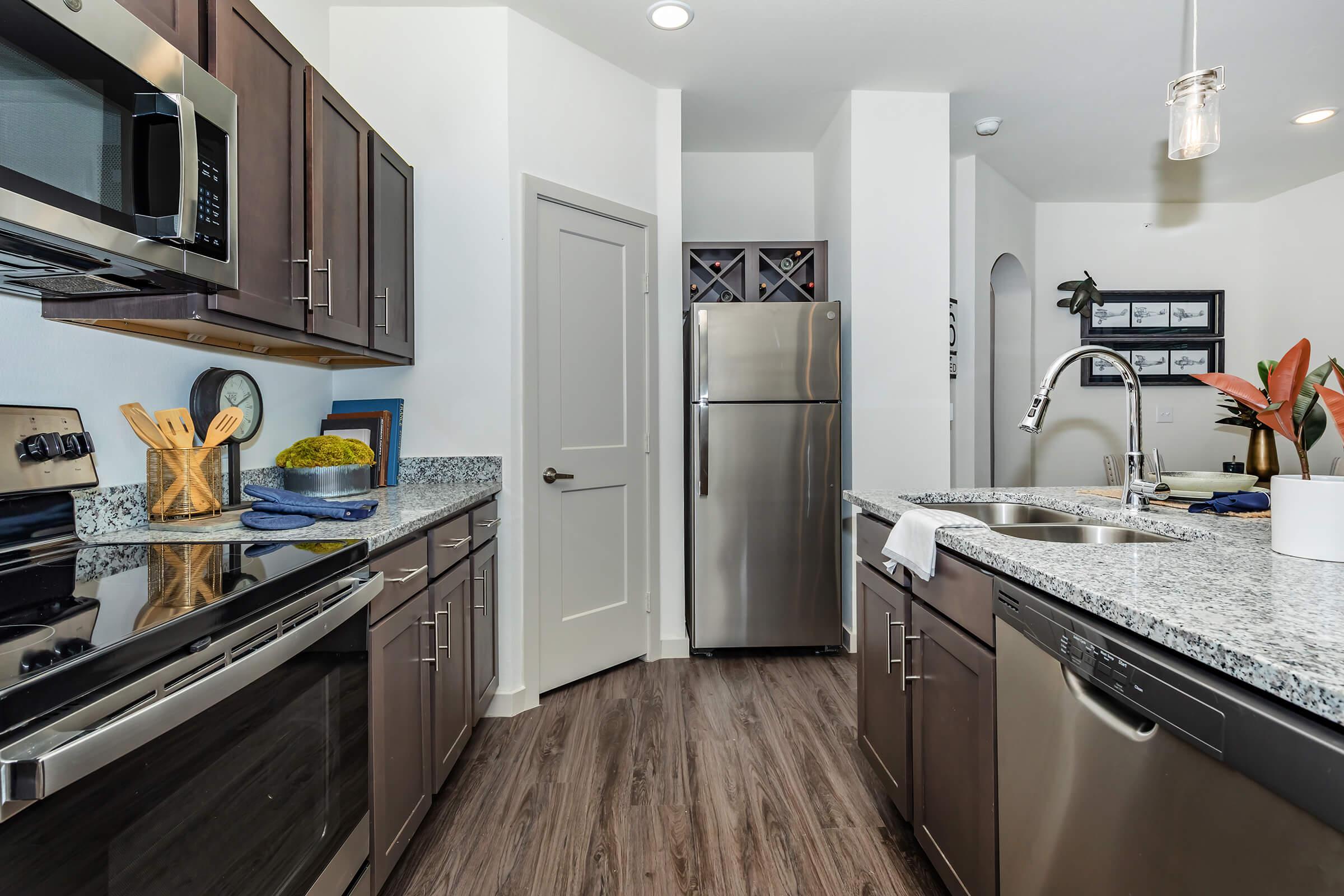 a kitchen with a sink and a mirror