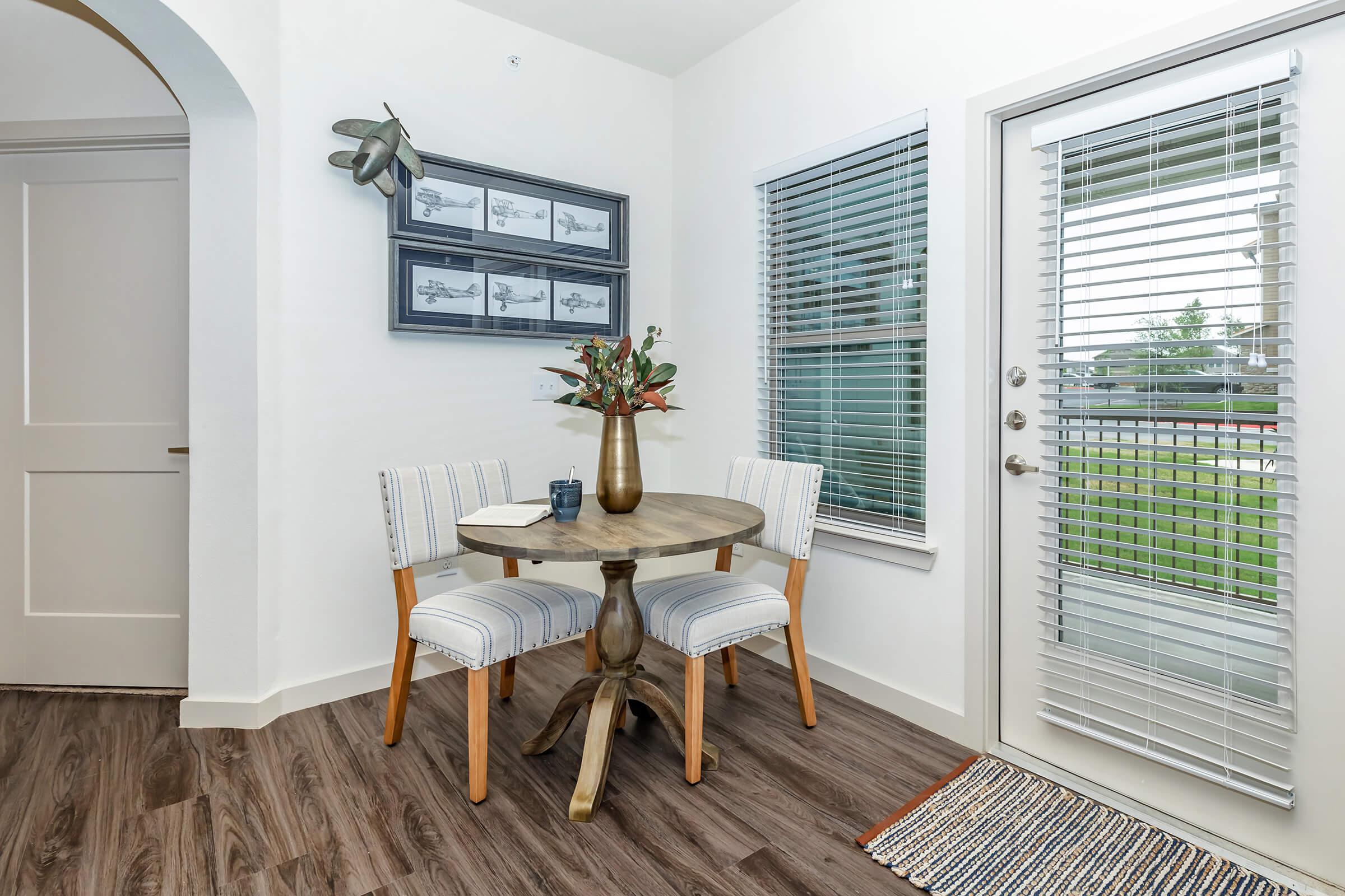 a living room filled with furniture and a large window