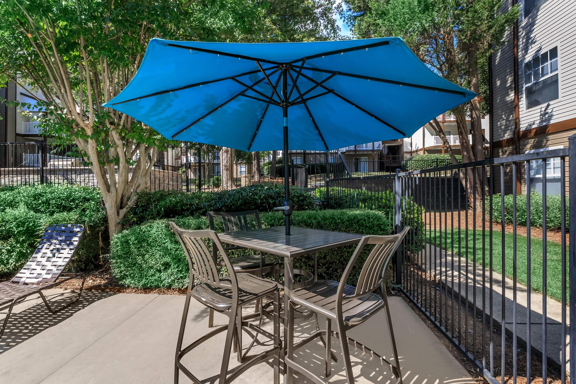 a table topped with a blue umbrella