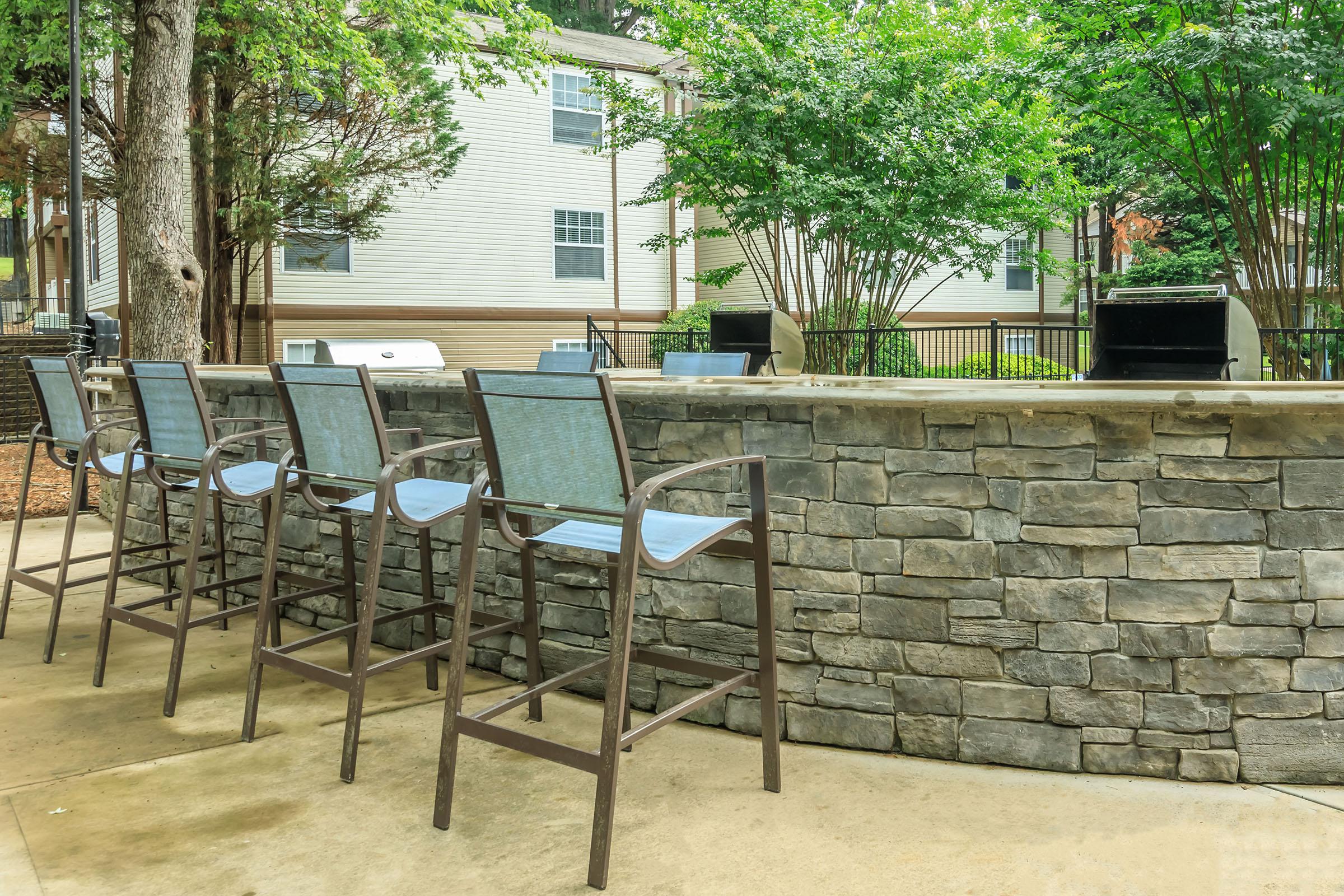 a group of lawn chairs sitting on top of a wooden table