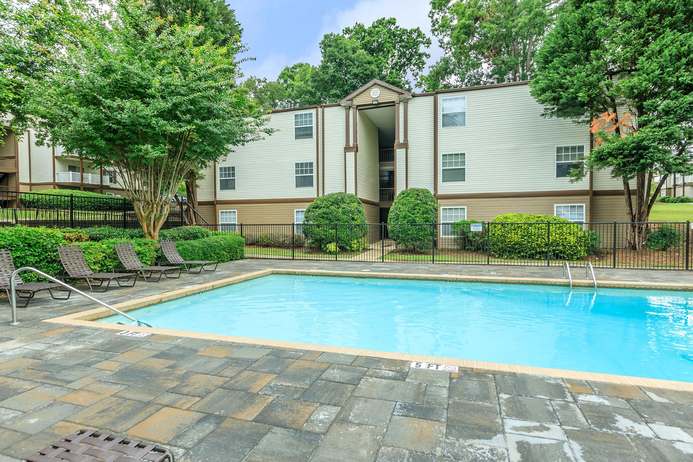 a house with a pool outside of a building