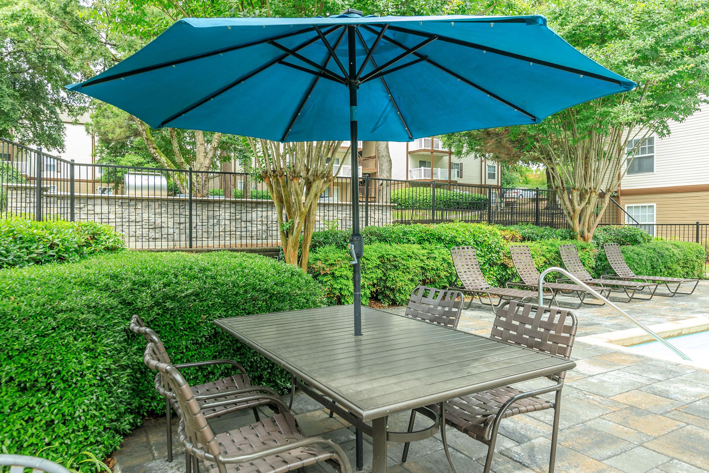 a table topped with a blue umbrella