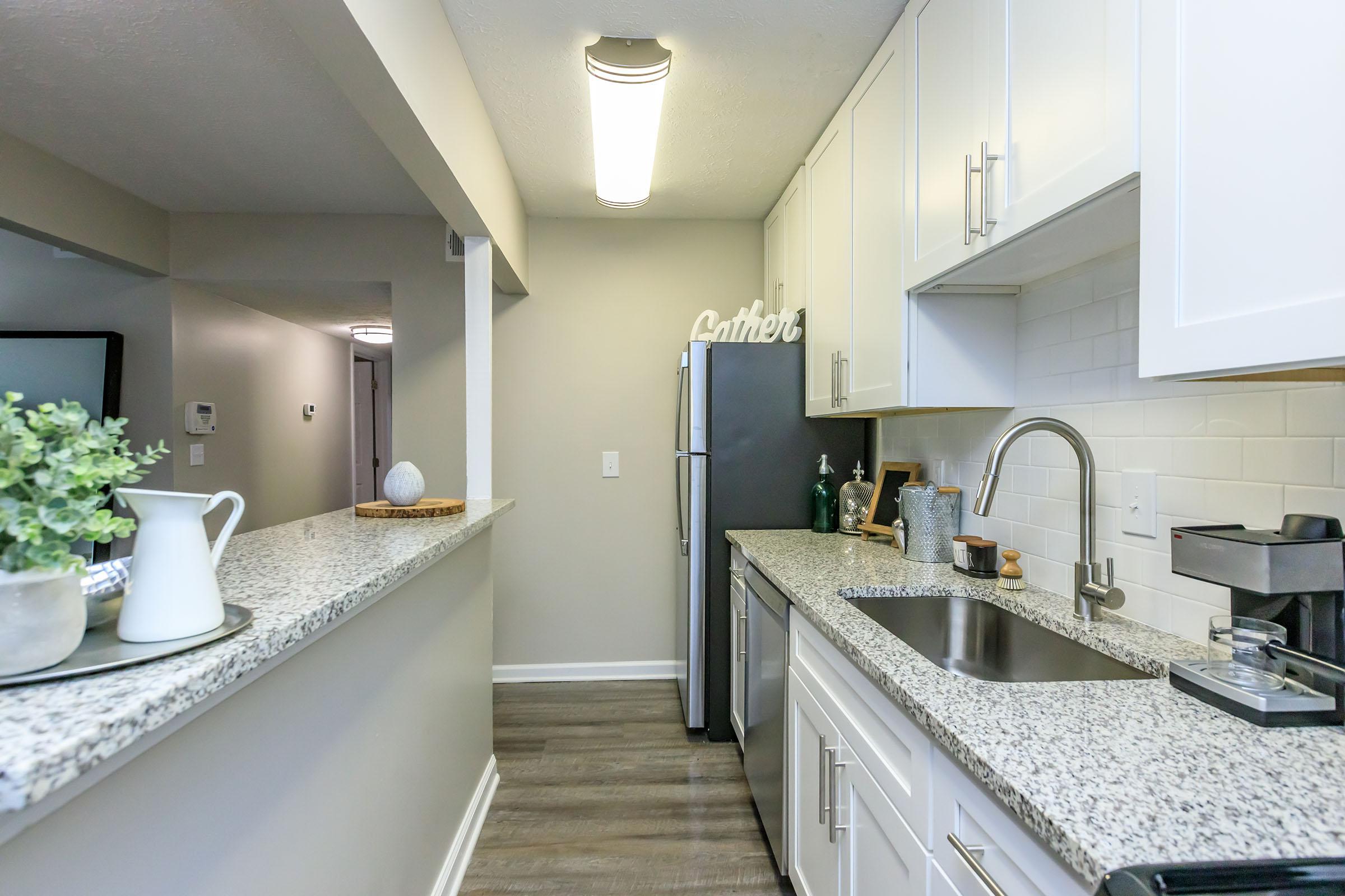 a kitchen with a sink and a mirror